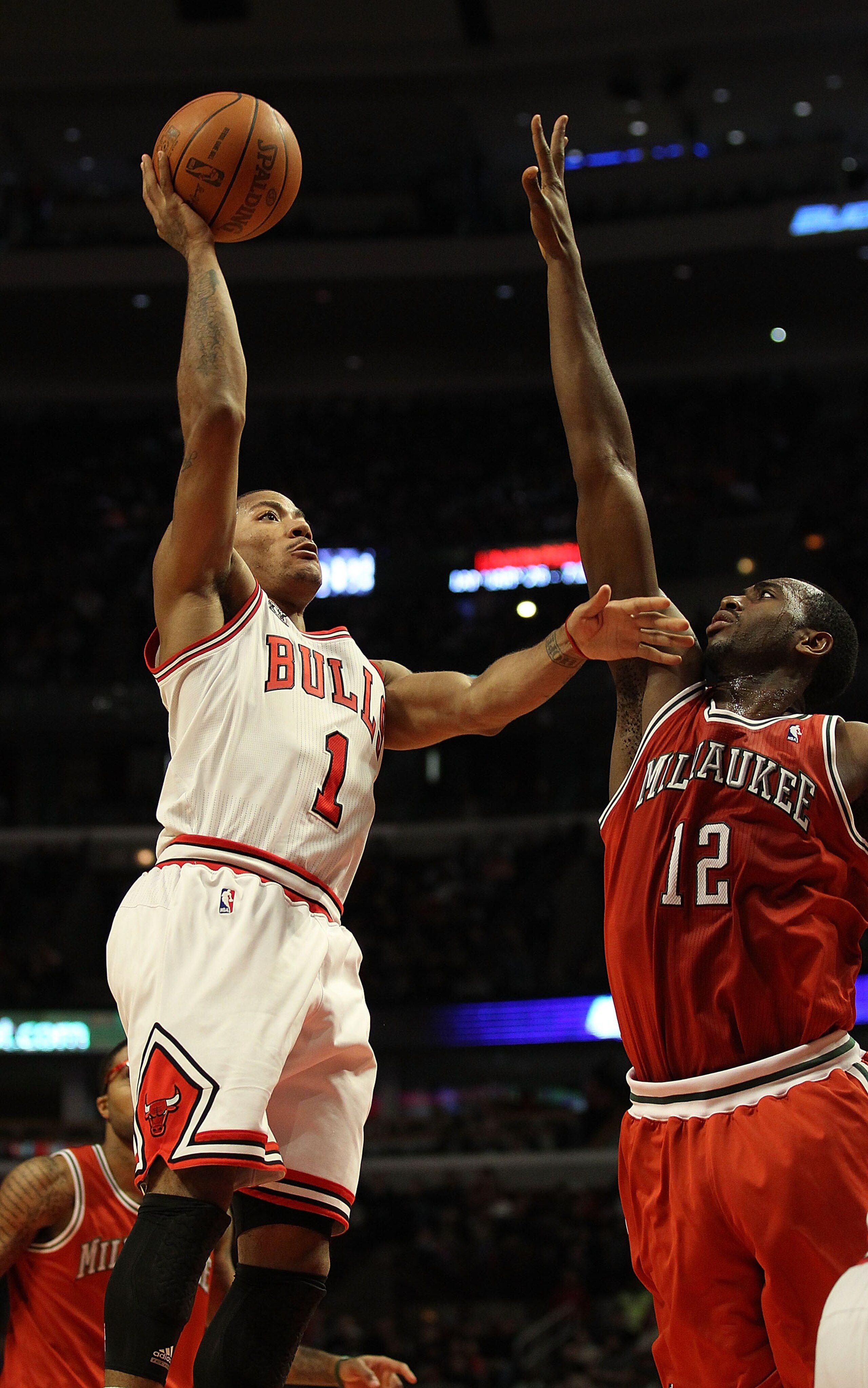 CHICAGO, IL - DECEMBER 28: Derrick Rose #1 of the Chicago Bulls shoots over Luc Mbah a Moute #12 of the Milwaukee Bucks at the United Center on December 28, 2010 in Chicago, Illinois. The Bulls defeated the Bucks 90-77. NOTE TO USER: User expressly acknow