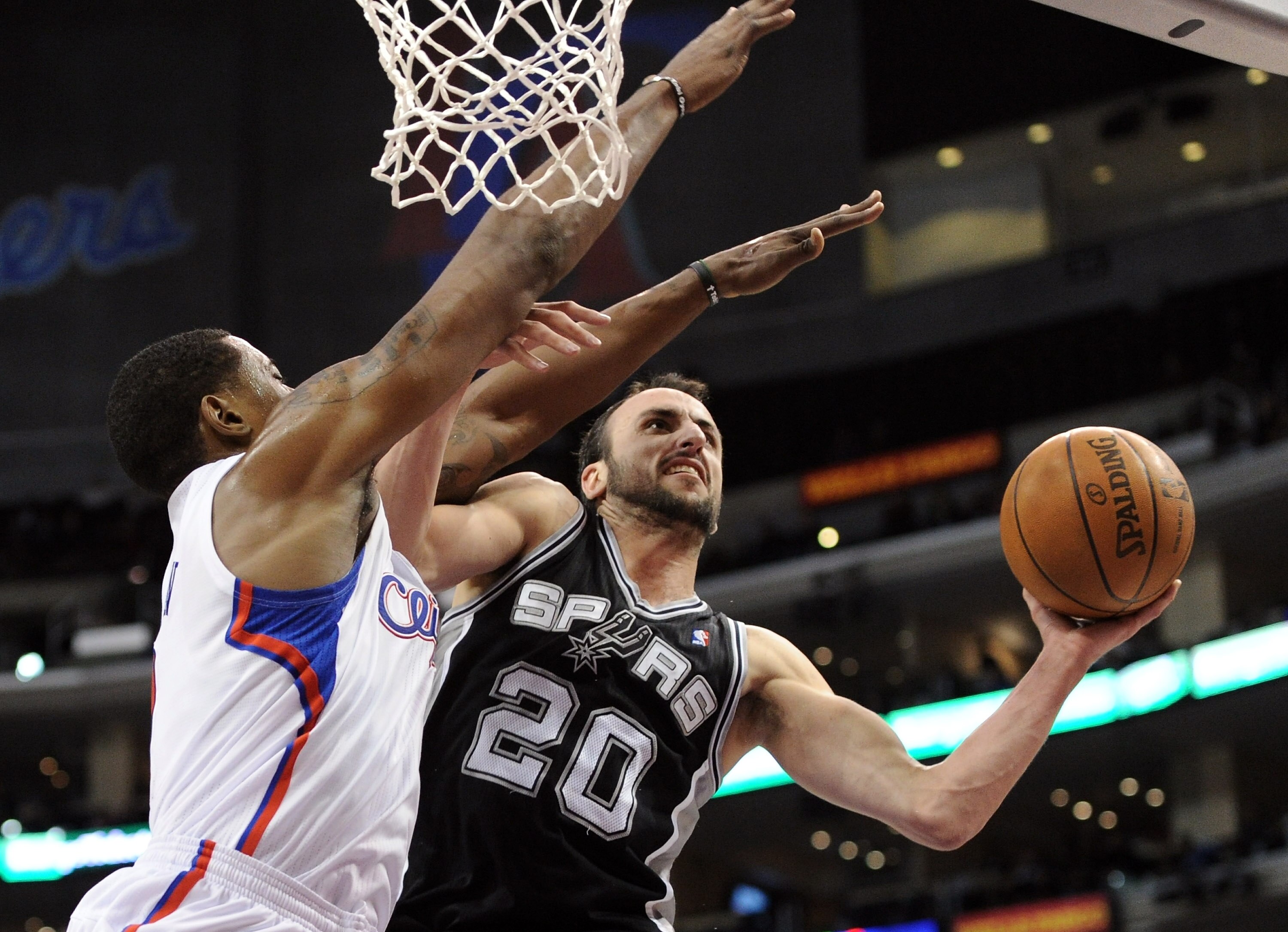 LOS ANGELES, CA - DECEMBER 01:  Manu Ginobili #20 of the San Antonio Spurs attempts a shot over the defense of DeAndre Jordan #9 of the Los Angeles Clippers during a 90-85 Clipper win at the Staples Center on December 1, 2010 in Los Angeles, California.  