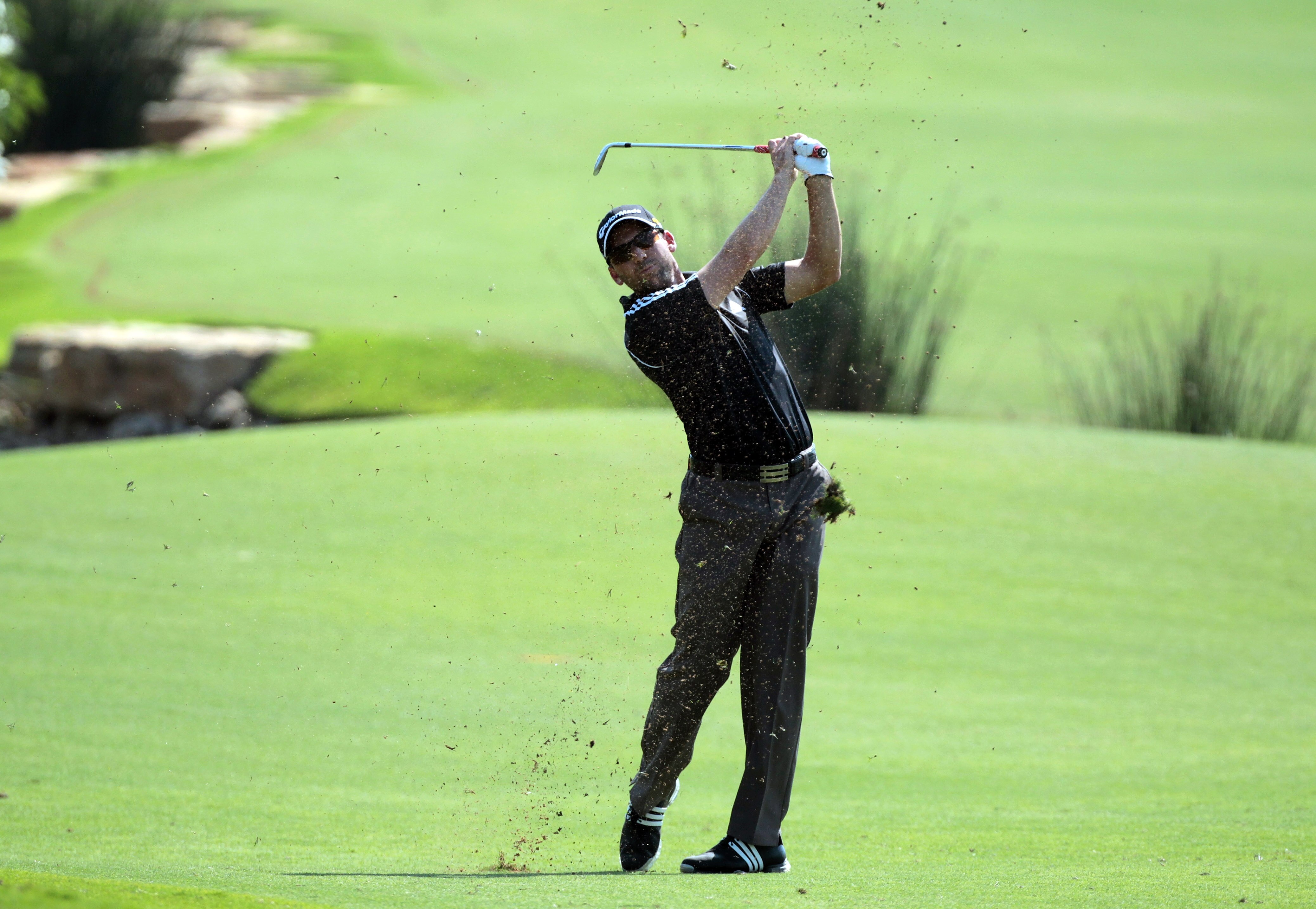 DUBAI, UNITED ARAB EMIRATES - NOVEMBER 25:  Sergio Garcia of Spain plays his third shot to the 18th hole during the first round of the Dubai World Championship on the Earth Course at Jumeirah Golf Estates on November 25, 2010 in Dubai, United Arab Emirate