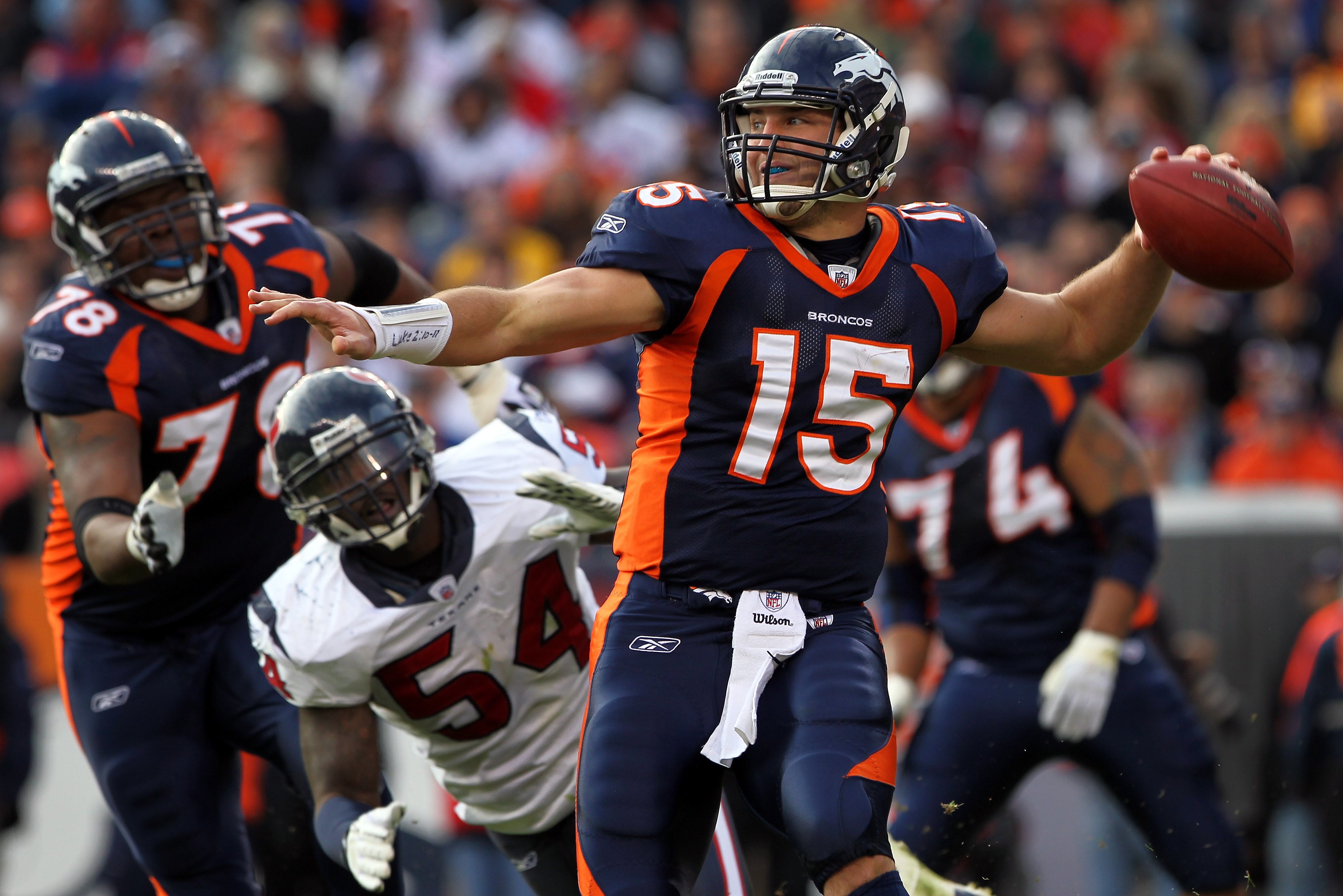 DENVER - DECEMBER 26:  Quarterback Tim Tebow #15 of the Denver Broncos rolls out and looks to deliver a pass against the Houston Texas at INVESCO Field at Mile High on December 26, 2010 in Denver, Colorado. The Broncos defeated the Texans 24-23.  (Photo b