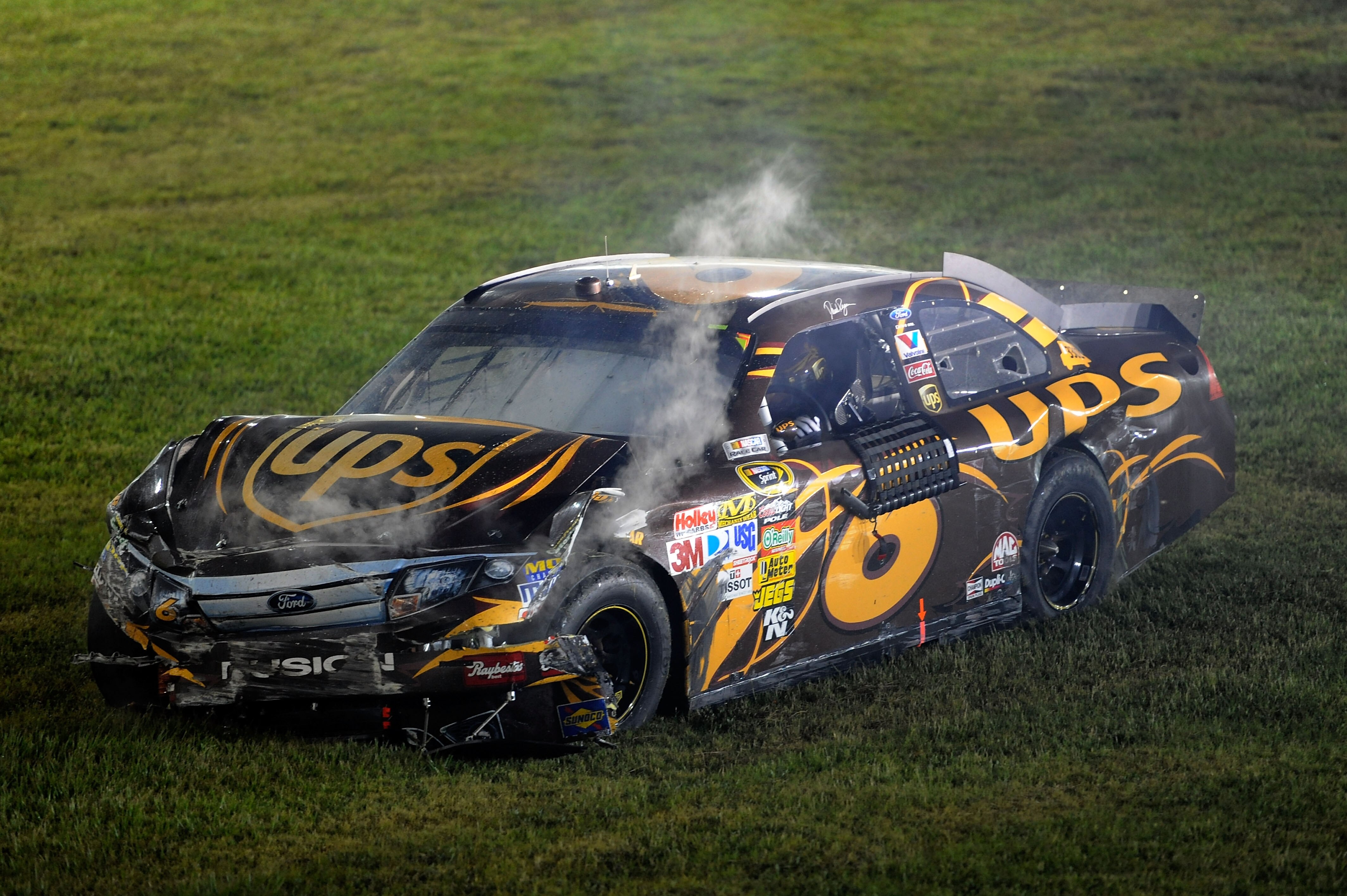 DAYTONA BEACH, FL - JULY 03:  David Ragan, driver of the #6 UPS Ford, sits in his car after crashing during the NASCAR Sprint Cup Series Coke Zero 400 at Daytona International Speedway on July 3, 2010 in Daytona Beach, Florida.  (Photo by John Harrelson/G