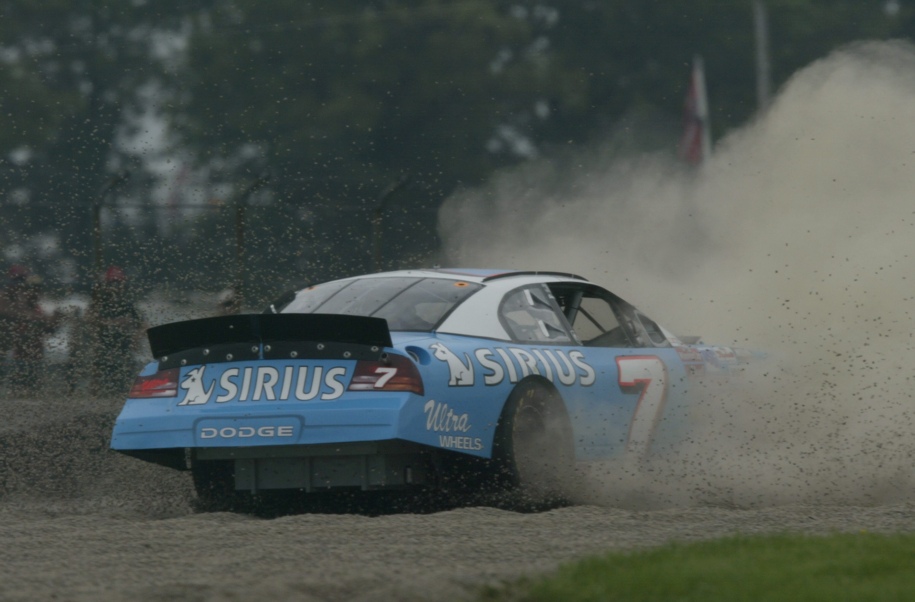 WATKINS GLEN, NY - AUGUST 9:  Jimmy Spencer #7, driver of the Sirius Satellite Dodge Intrepid, loses control of his car during practice for the Sirius at The Glen Winston Cup Race on August 9, 2003 at Watkins Glen International in Watkins Glen, New York.