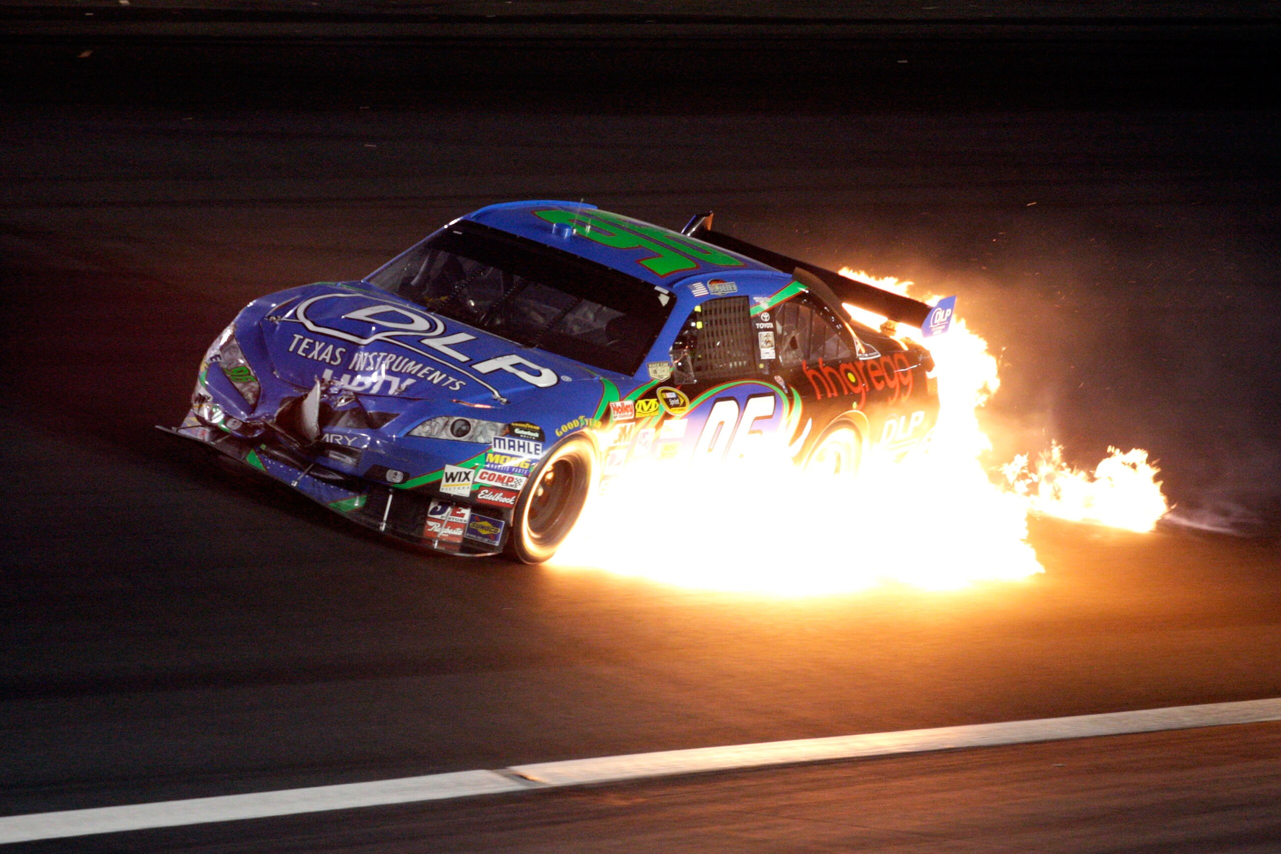 CONCORD, NC - MAY 25:  J.J. Yeley, driver of the #96 DLP HDTV Toyota, spills out fire after an incident during the NASCAR Sprint Cup Series Coca-Cola 600 on May 25, 2008 at Lowe's Motor Speedway in Concord, North Carolina.  (Photo by John Harrelson/Getty