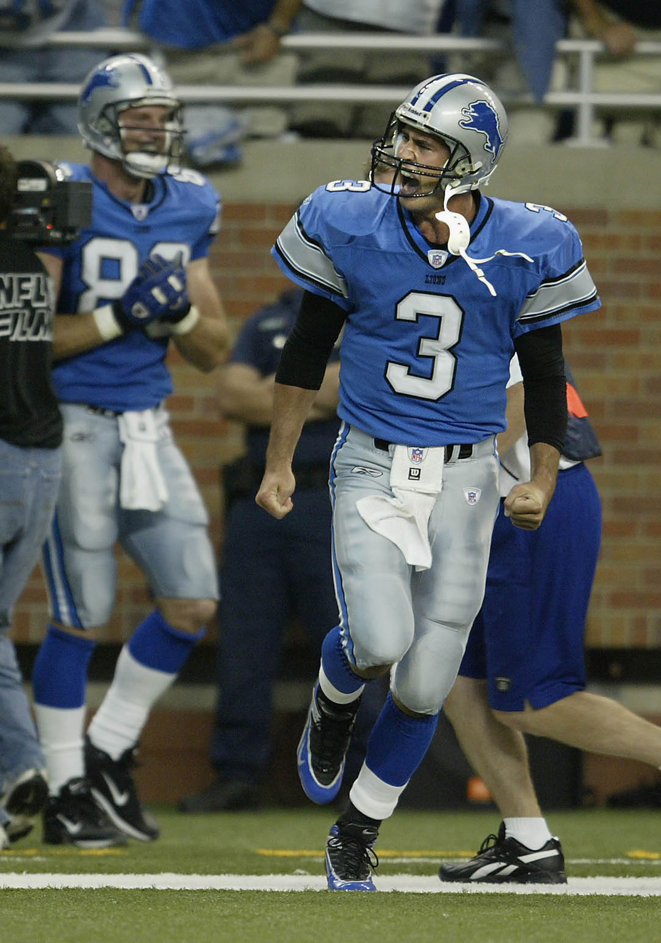 DETROIT, MI - SEPTEMBER 19: Joey Harrington #3 of the Detroit Lions celebrates his second touchdown pass of the game to teammate Roy Williams against the Houston Texans at Ford Field on September 19, 2004 in Detroit, Michigan. The Lions won the game 28-16