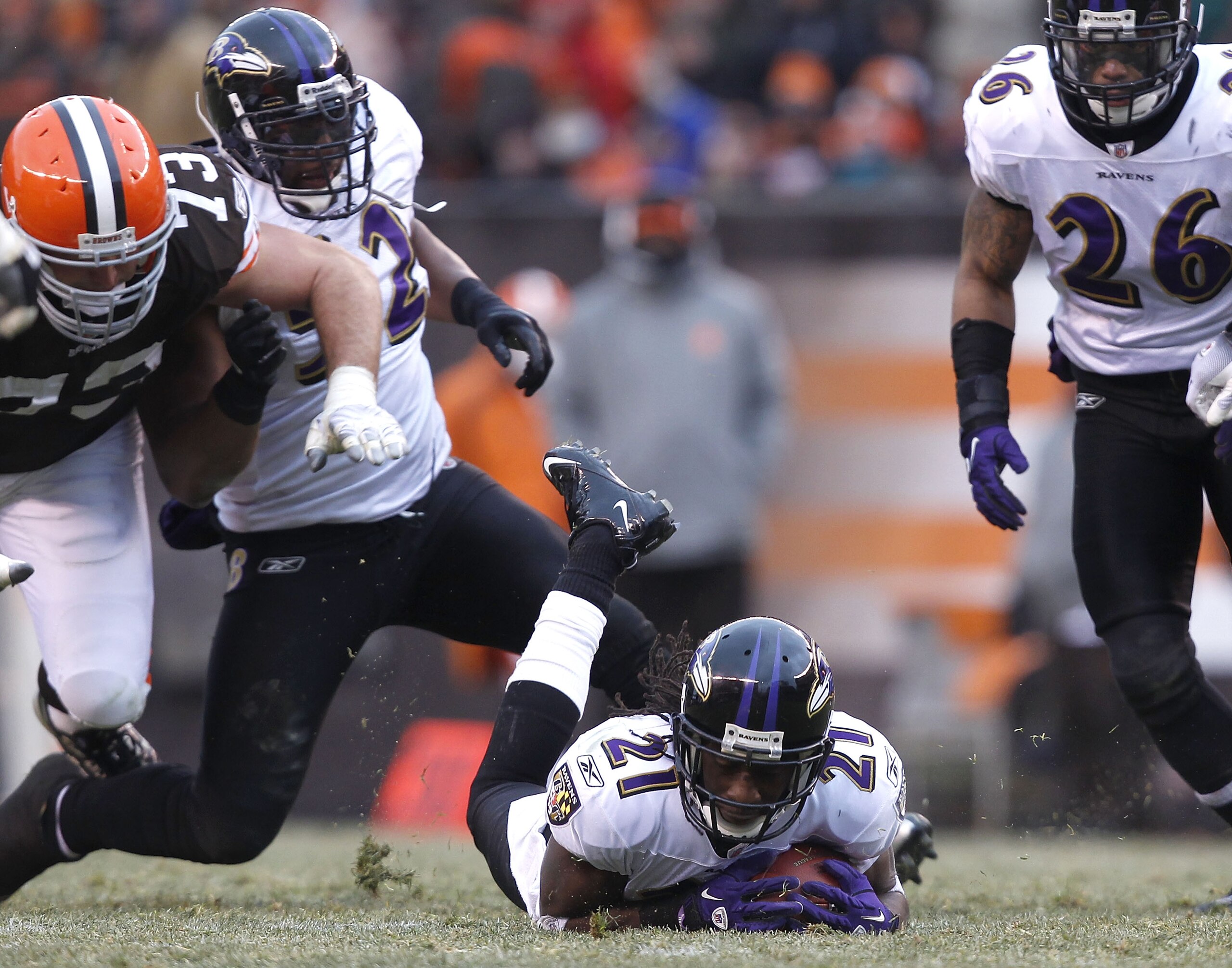 CLEVELAND - DECEMBER 26:  Cornerback Lardarius Webb #21 of the Baltimore Ravens recovers a fumble as Ray Lewis #52, Dawan Landry #26 and lineman Joe Thomas #73 of the Cleveland Browns look on at Cleveland Browns Stadium on December 26, 2010 in Cleveland,