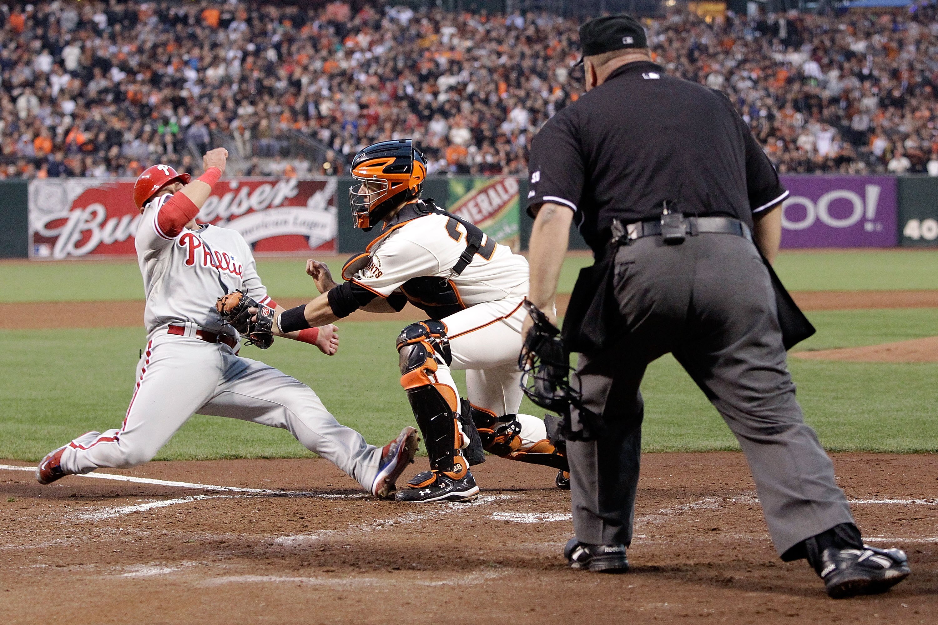 SAN FRANCISCO - OCTOBER 20:  Carlos Ruiz #51 of the Philadelphia Phillies is tagged out at the plate by catcher Buster Posey #28 of the San Francisco Giants in the fifth inning of Game Four of the NLCS during the 2010 MLB Playoffs at AT&T Park on October