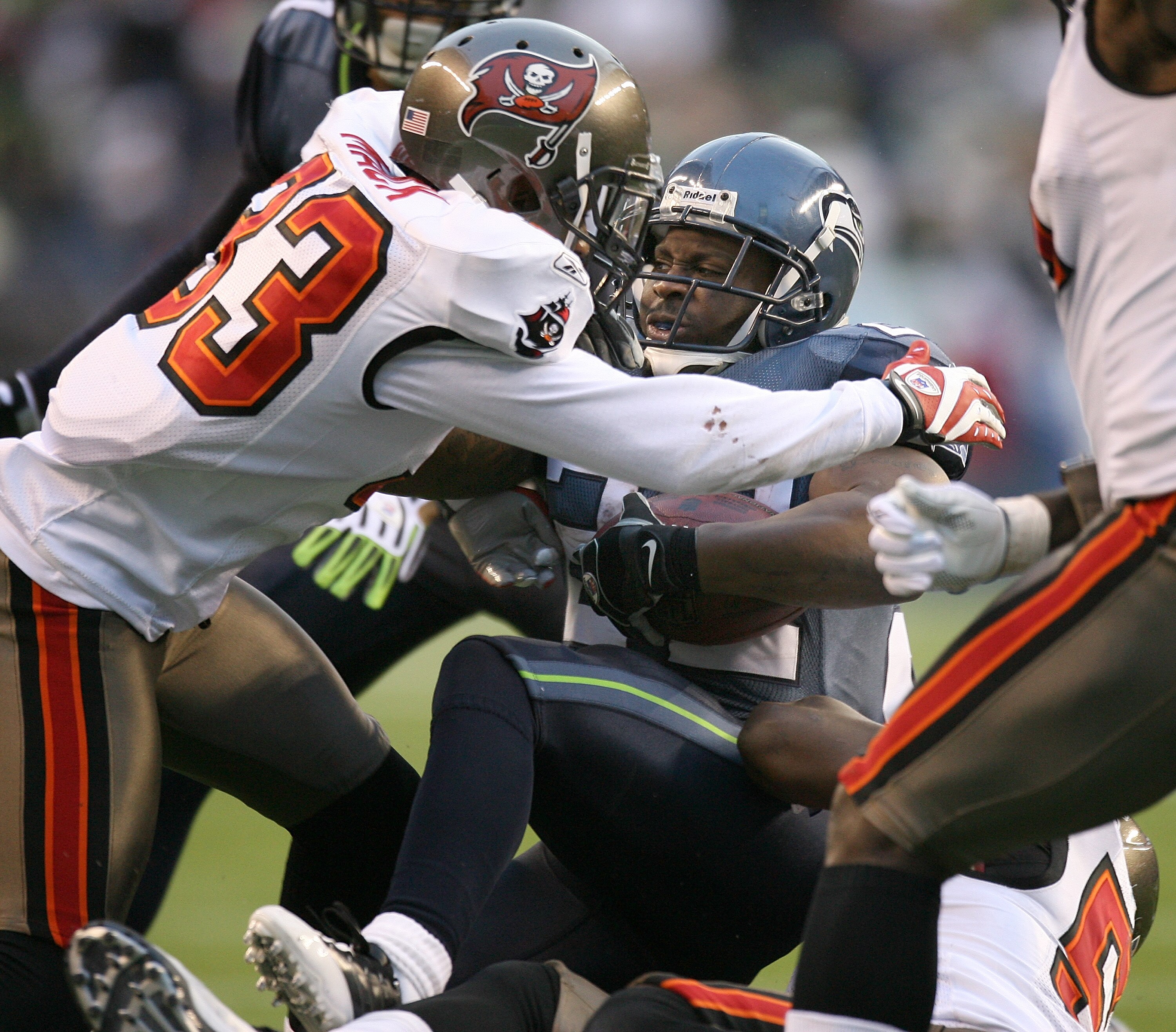 SEATTLE - DECEMBER 20:  Running back Julius Jones #22 of the Seattle Seahawks is tackled by Elbert Mack #33 of the Tampa Bay Buccaneers on December 20, 2009 at Qwest Field in Seattle, Washington. The Buccaneers defeated the Seahawks 24-7. (Photo by Otto G