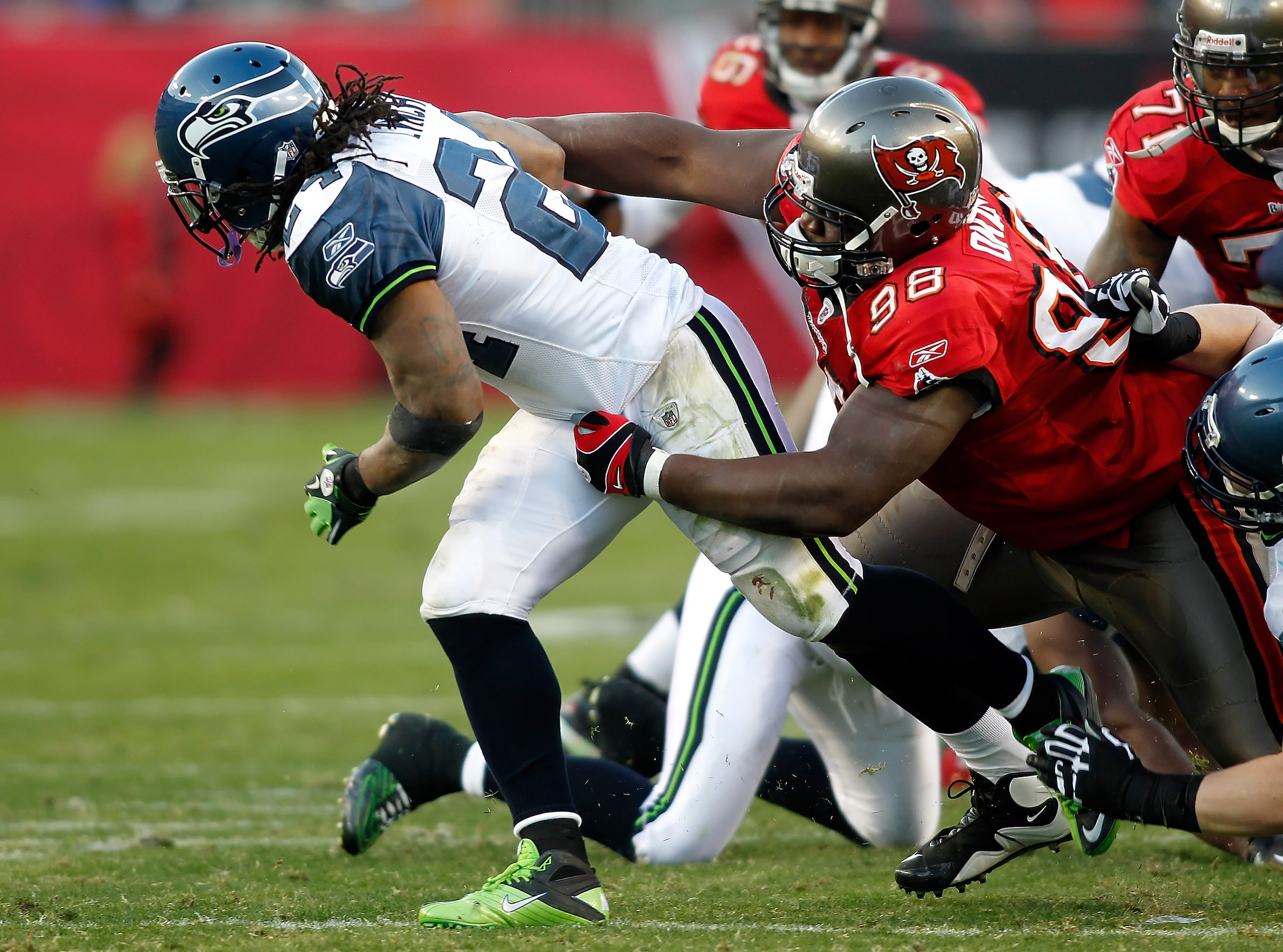 TAMPA, FL - DECEMBER 26: Defensive tackle Frank Okam #98 of the Tampa Bay Buccaneers tackles running back Marshawn Lynch #24 of the Seattle Seahawks during the game at Raymond James Stadium on December 26, 2010 in Tampa, Florida. (Photo by J. Meric/Getty