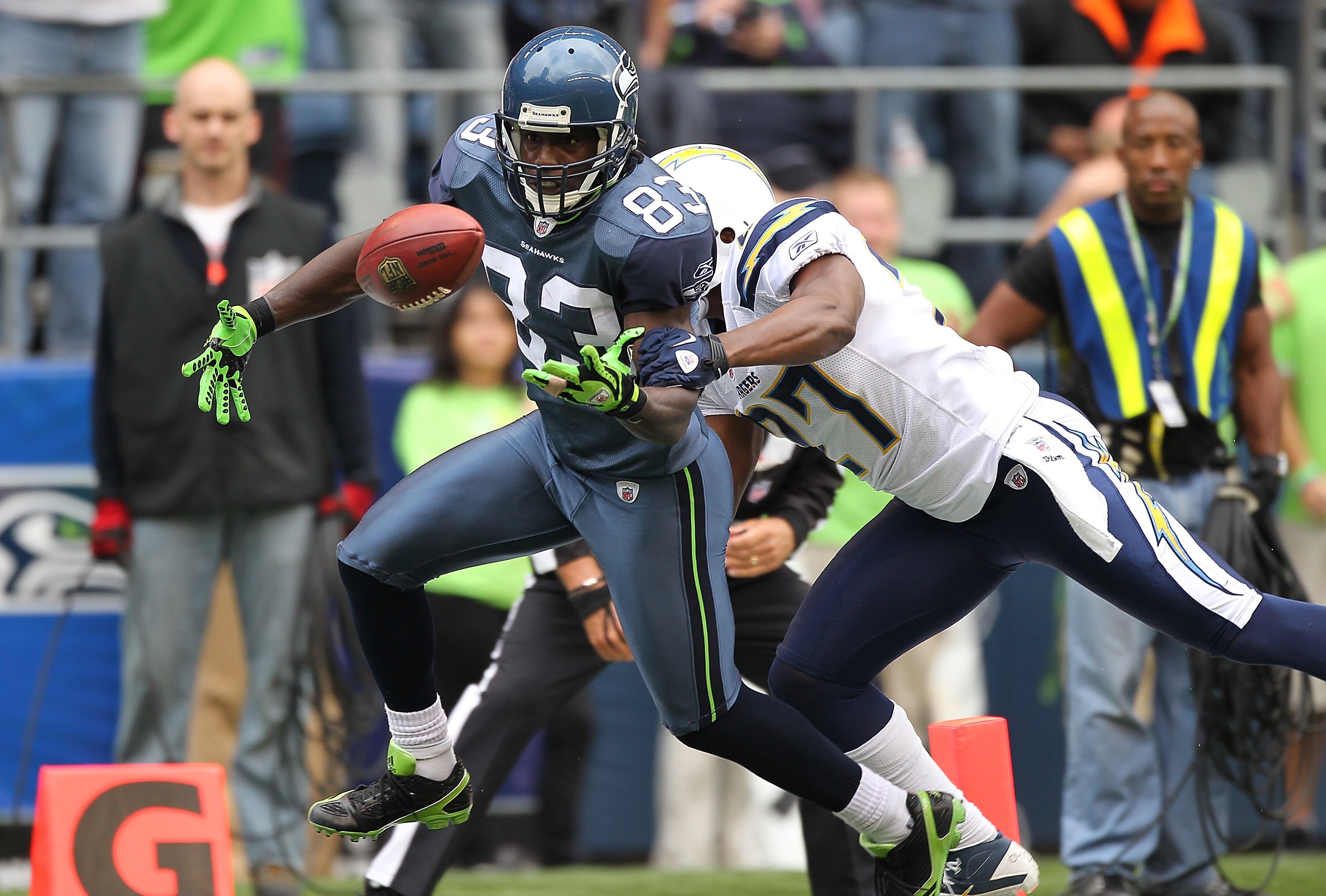 SEATTLE - SEPTEMBER 26:  Wide receiver Deion Branch #83 of the Seattle Seahawks looses possession of the ball as he crosses the goal line against Paul Oliver #27 of the San Diego Chargers at Qwest Field on September 26, 2010 in Seattle, Washington. The to