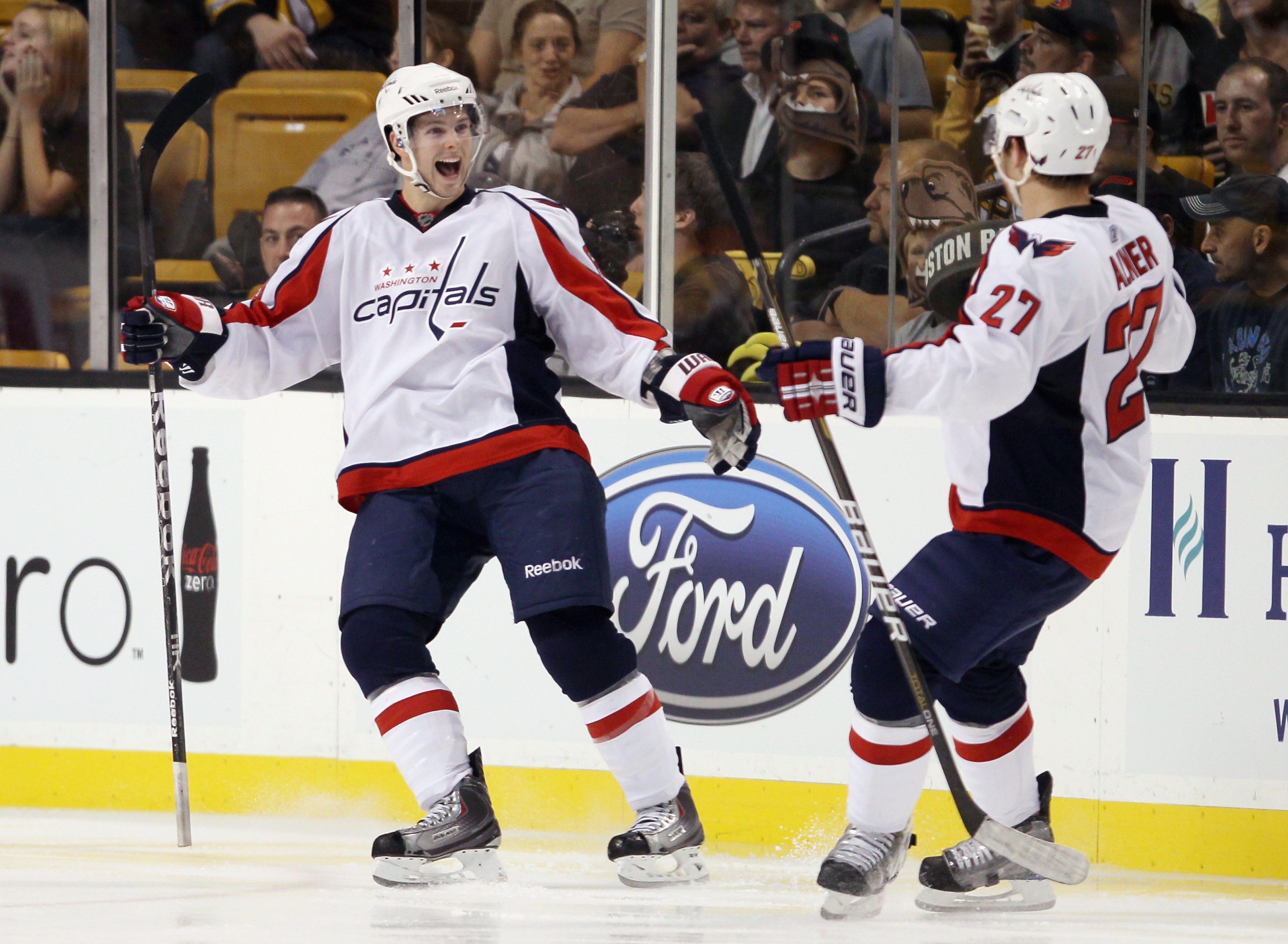 BOSTON - SEPTEMBER 29:  Andrew Gordon #63 and Karl Alzner #27 of the Washington Capitals celebrate a goal in the third period against the Boston Bruins on September 29, 2010 at the TD Garden in Boston, Massachusetts. The Capitals defeated the Bruins 4-1.
