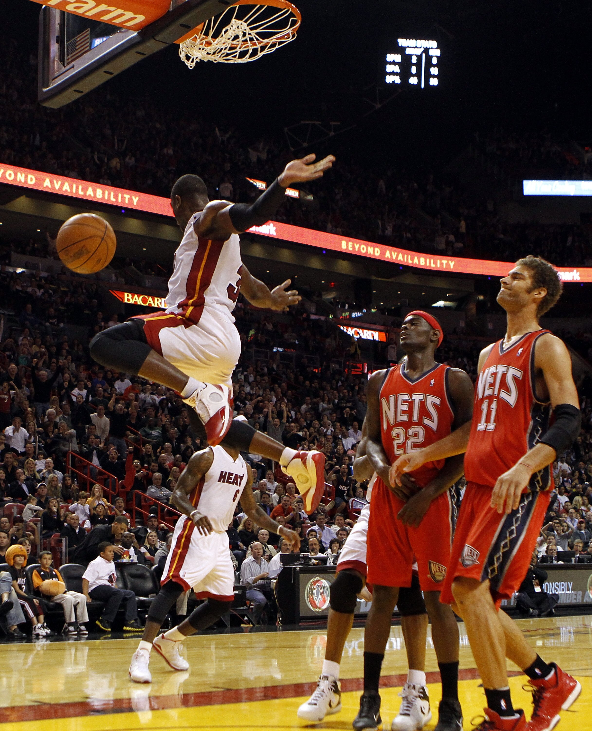 MIAMI - NOVEMBER 06:  Guard Dwyane Wade #3 of the Miami Heat dunks against forward guard Anthony Morrow #22 and center Brook Lopez #11  of the New Jersey Nets  at American Airlines Arena on November 6, 2010 in Miami, Florida. NOTE TO USER: User expressly