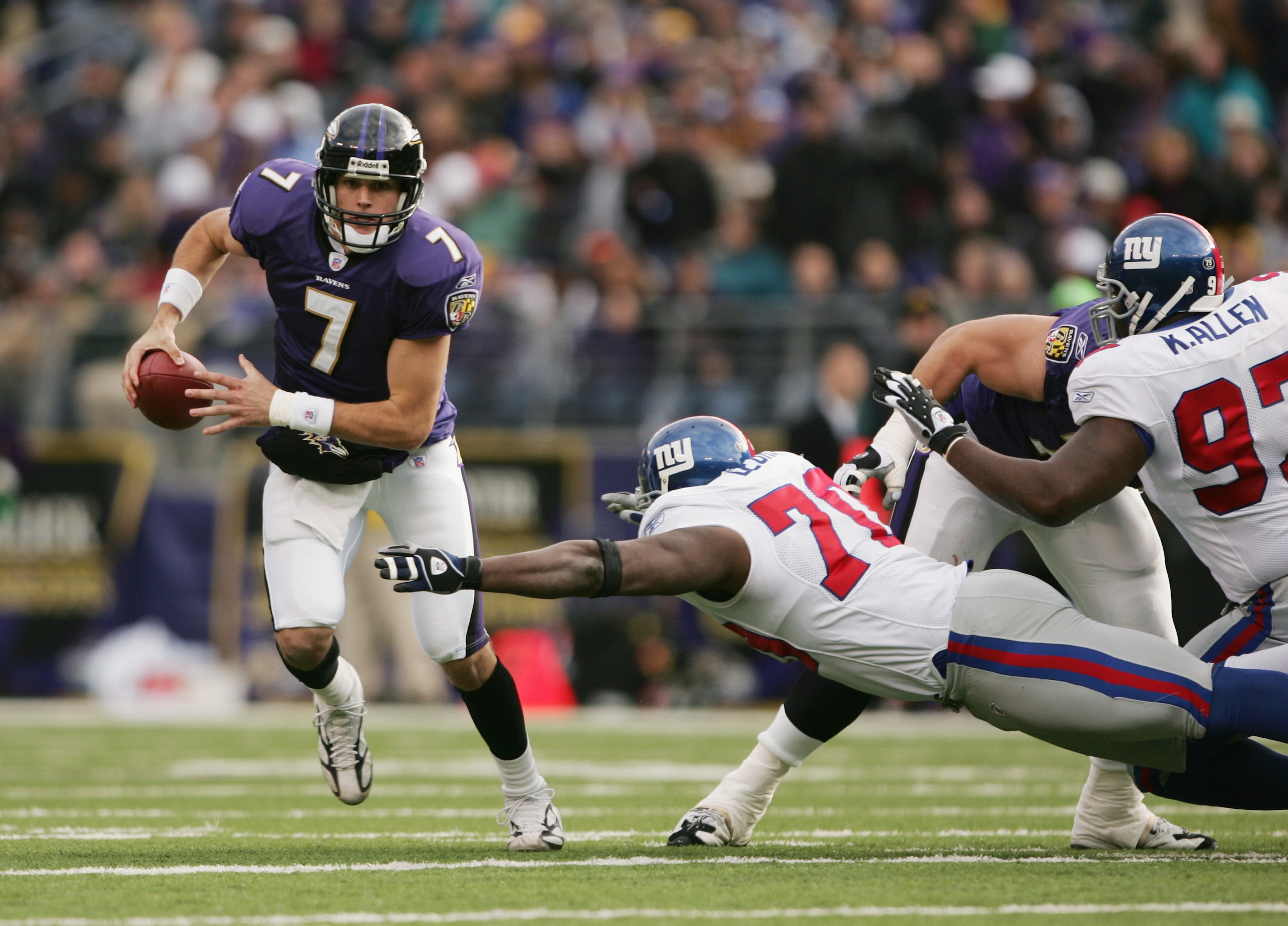 BALTIMORE - DECEMBER 12:  Quarterback Kyle Boller #7 of the Baltimore Ravens evades defensive tackle Lance Legree #70 of the New York Giants during the game at M&T Bank Stadium on December 12, 2004 in Baltimore, Maryland. The Ravens defeated the Giants 37