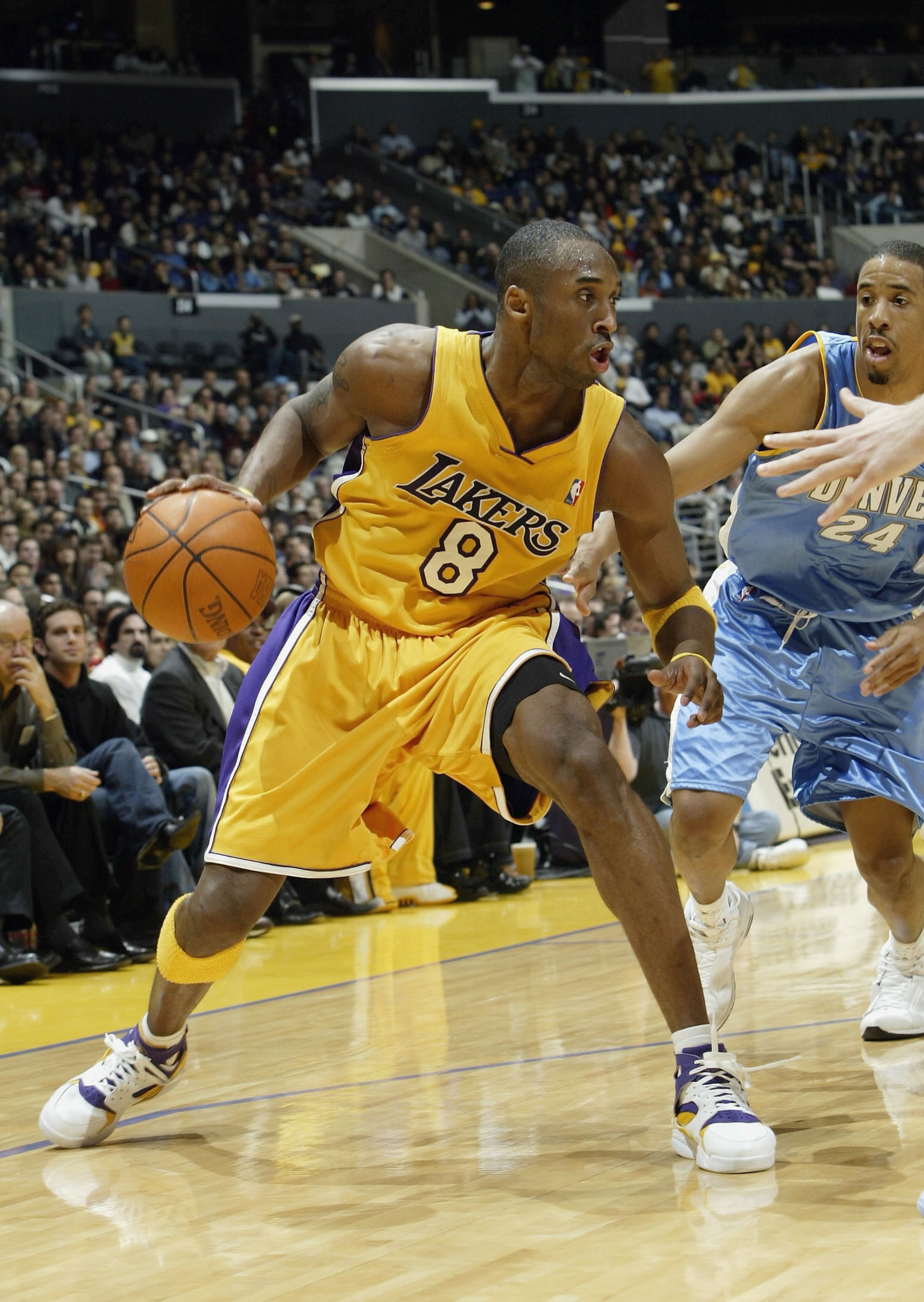 LOS ANGELES - DECEMBER 19:  Kobe Bryant #8 of the Los Angeles Lakers controls the ball in front of Andre Miller #24 of the Denver Nuggets on December 19, 2003 at Staples Center in Los Angeles, California.  The Lakers won 101-99. (Photo by Stephen Dunn/Get