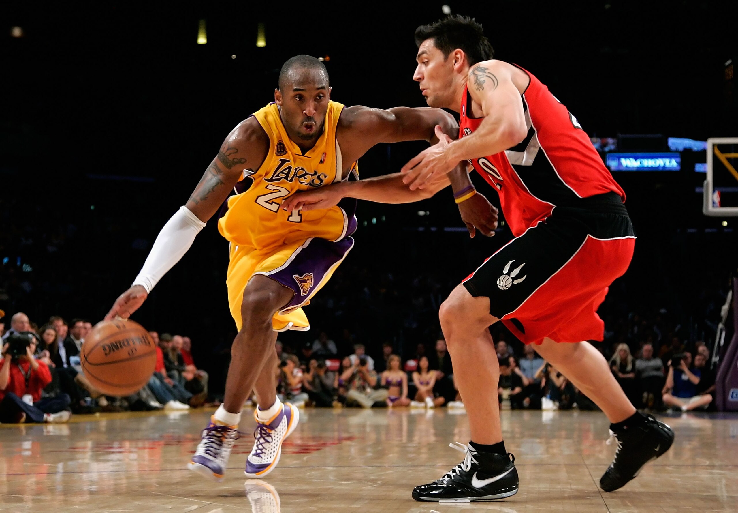 LOS ANGELES, CA - MARCH 11:  Kobe Bryant #24 of the Los Angeles Lakers drives with the ball against Carlos Delfino #20 of the Toronto Raptors during the NBA game at Staples Center on March 11, 2008 in Los Angeles, California.  The Lakers defeated the Rapt