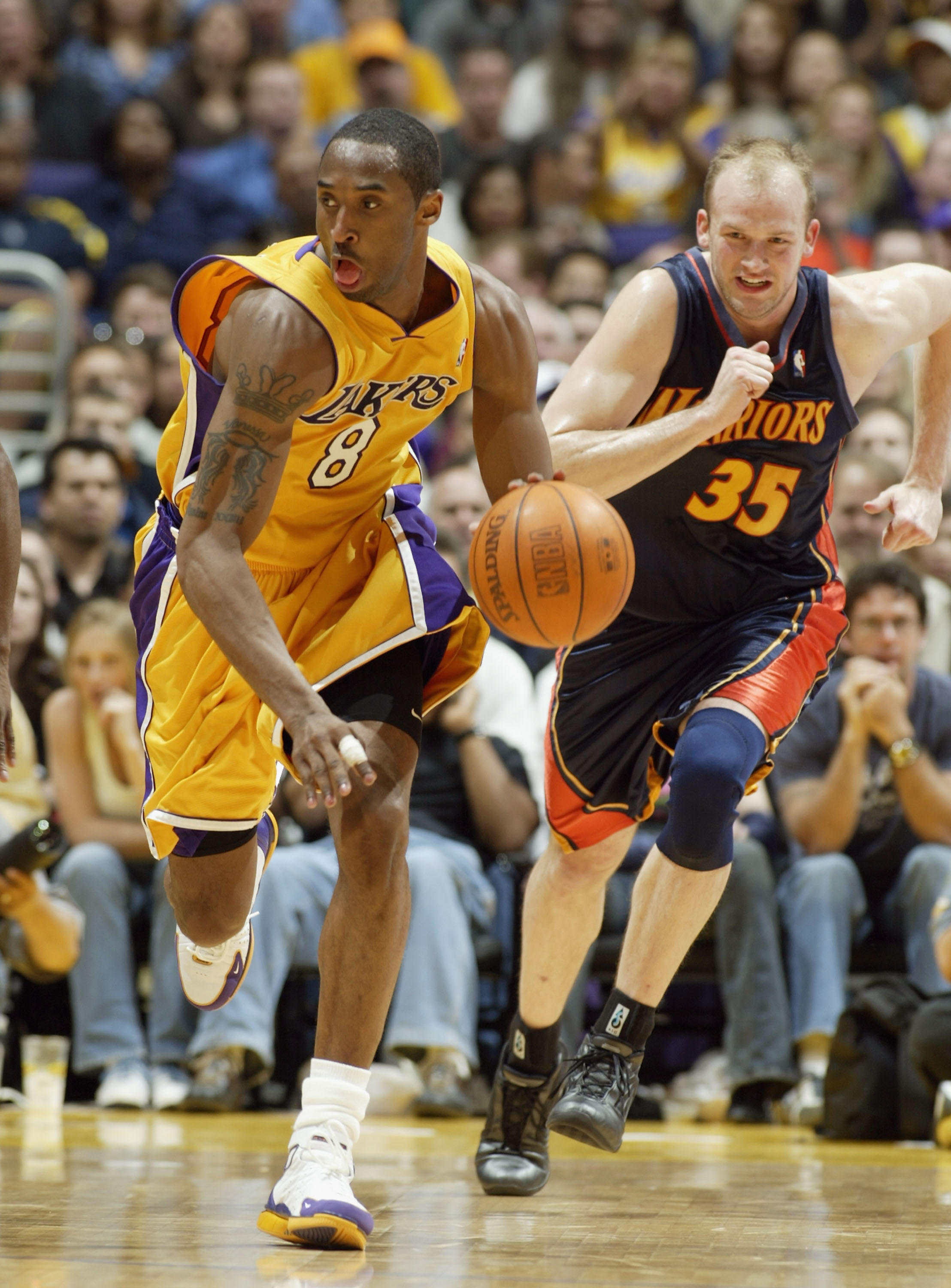 LOS ANGELES - APRIL 13:  Kobe Bryant #8 of the Los Angeles Lakers drives upcourt ahead of Brian Cardinal #35 of the Golden State Warriors during the game at Staples Center on April 13, 2004 in Los Angeles, California.  NOTE TO USER: User expressly acknowl