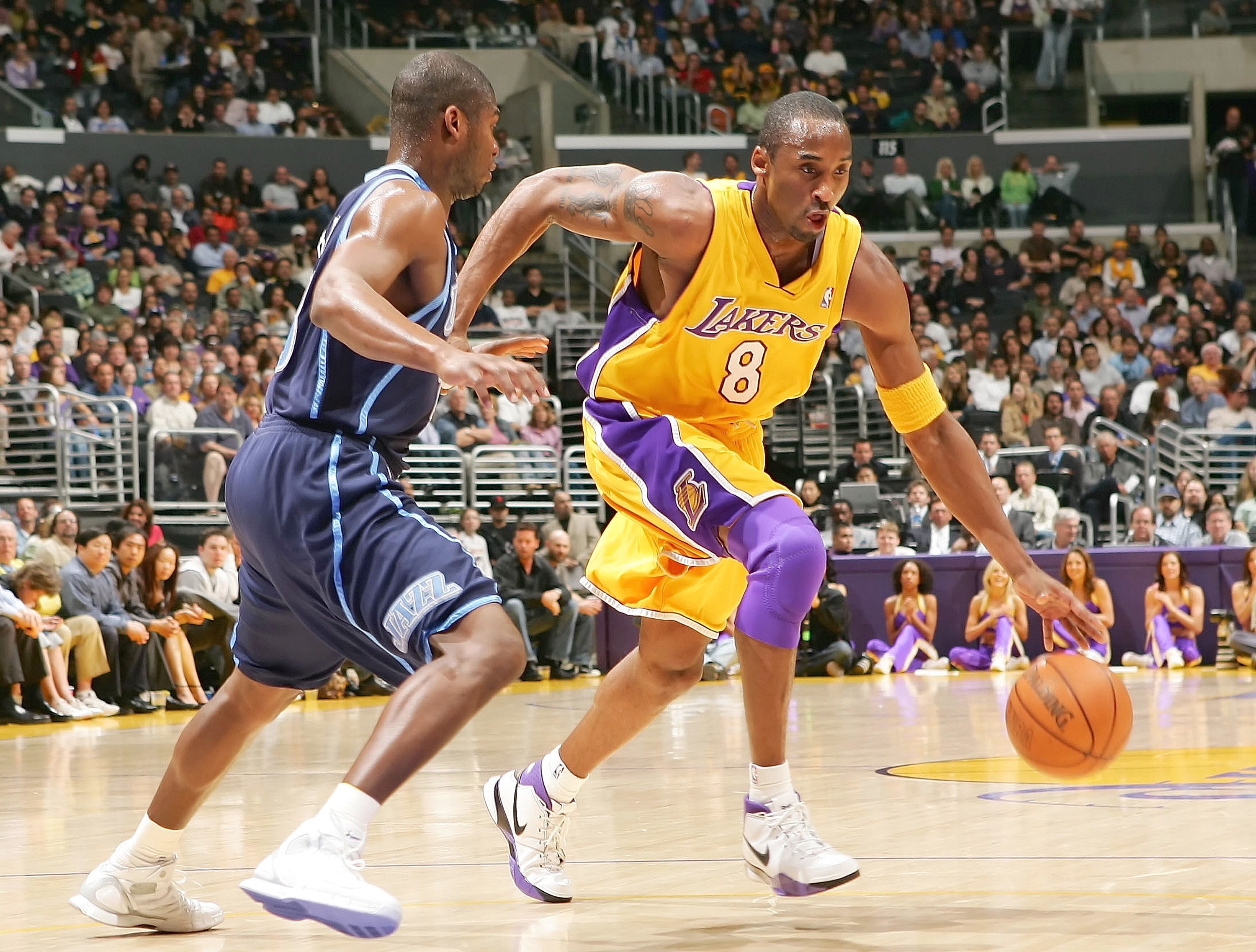 LOS ANGELES - FEBRUARY 13:  Kobe Bryant #8 of the Los Angeles Lakers drives against Devin Brown #23 of the Utah Jazz on February 13, 2006 at Staples Center in Los Angeles, California.  NOTE TO USER:  User expressly acknowledges and agrees that, by downloa