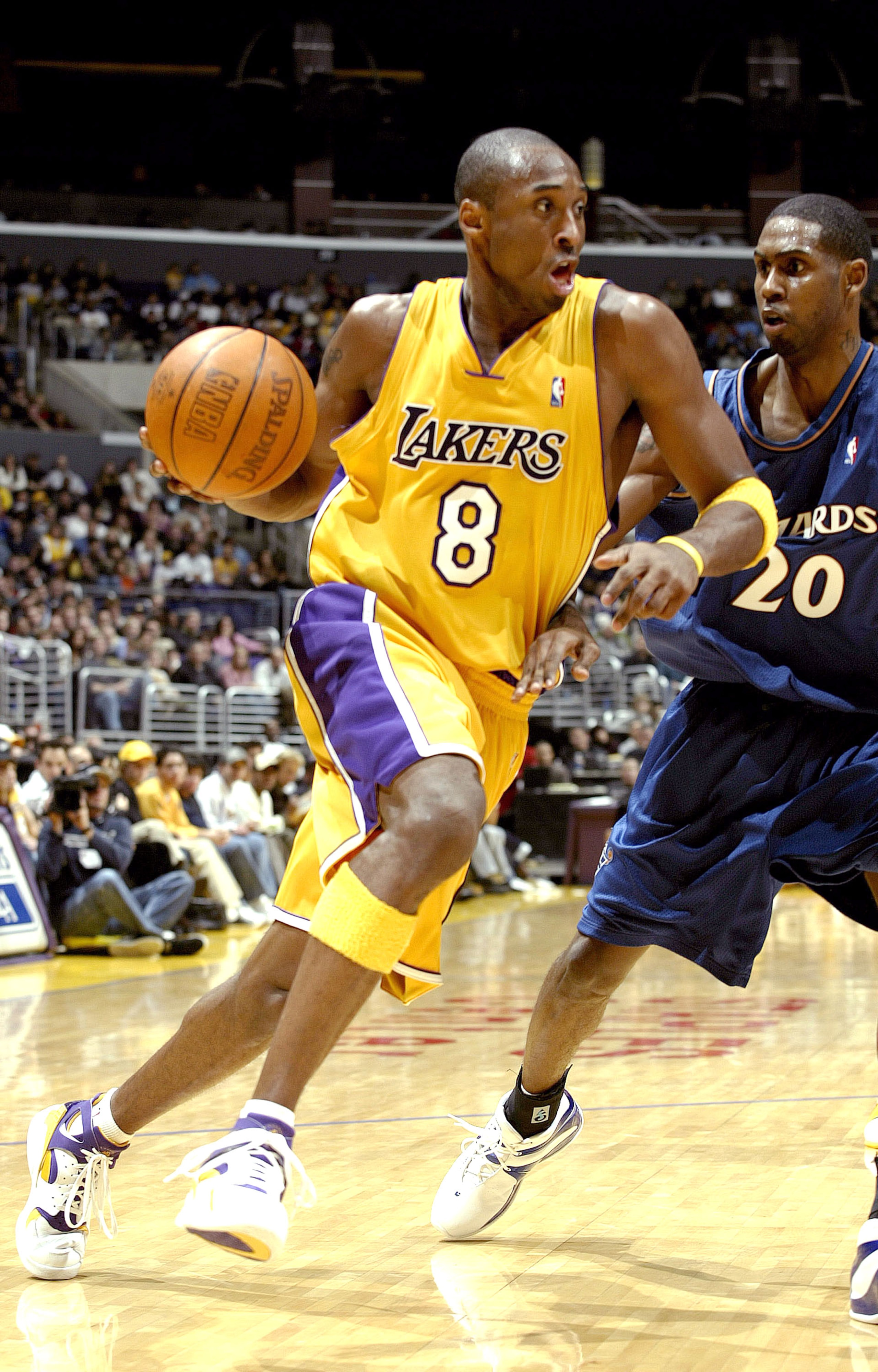 LOS ANGELES - NOVEMBER 26:  Kobe Bryant #8 of the Los Angeles Lakers drives to the basket past Larry Hughes #20 of the Washington Wizards during the game on November 26, 2003 at Staples Center in Los Angeles, California.  NOTE TO USER: User expressly ackn