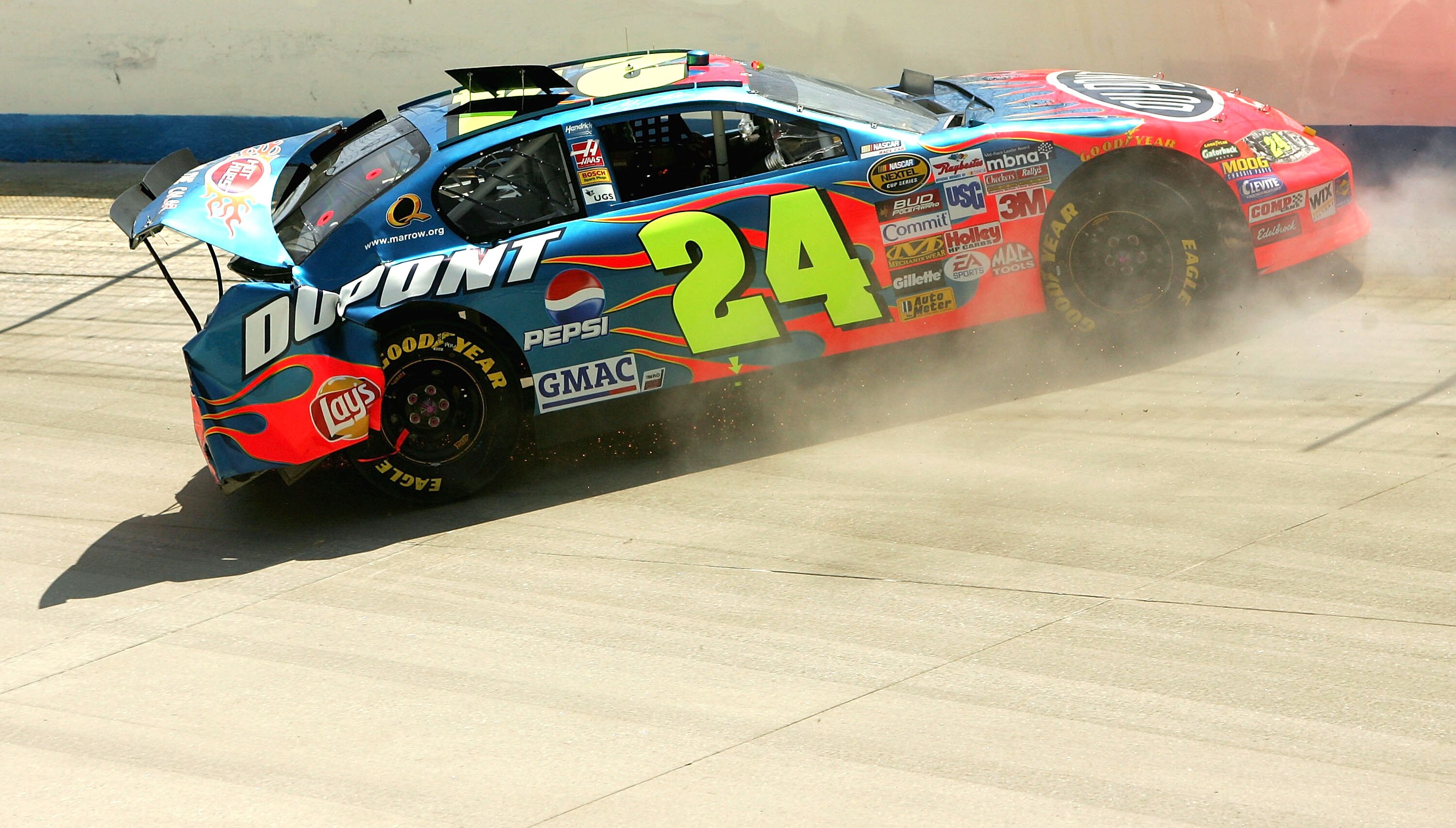 DOVER, DE - JUNE 5:  Jeff Gordon driver of the #24 DuPont Chevrolet crashes during the NASCAR Nextel Cup MBNA RacePoints 400 on June 5, 2005 at the Dover Internation Speedway in Dover, Delaware.  (Photo by Nick Laham/Getty Images)