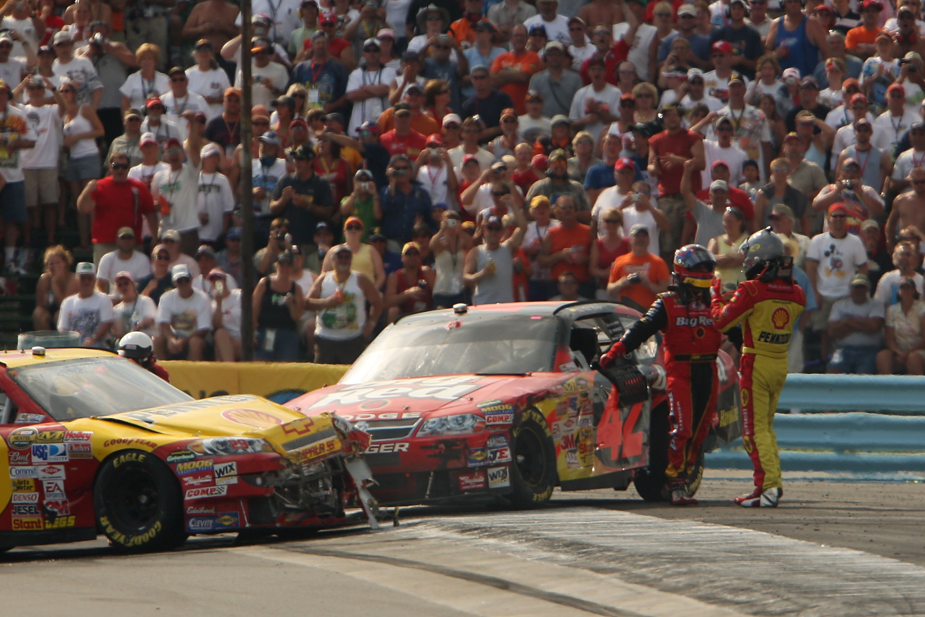 WATKINS GLEN, NY - AUGUST 12:  Juan Pablo Montoya, driver of the #42 Wrigley's Big Red Dodge, and Kevin Harvick, driver of the #29 Shell/Pennzoil Chevrolet, exchange words after crashing into each other during the NASCAR Nextel Cup Series Centurion Boats