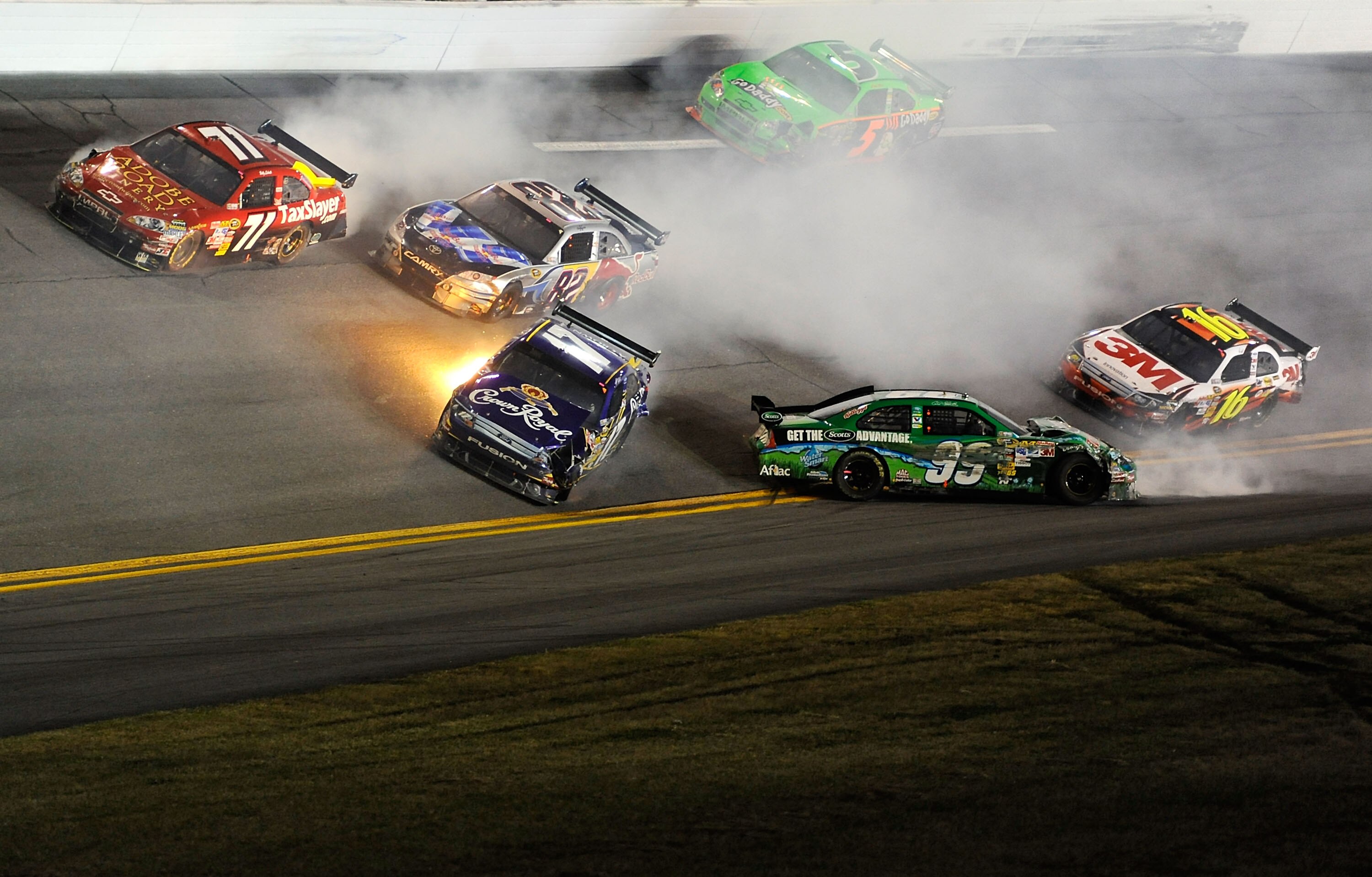 DAYTONA BEACH, FL - FEBRUARY 06:  Carl Edwards, driver of the #99 Scotts Ford and Matt Kenseth, driver of the #17 Crown Royal Ford, loses control of their cars after crashing during the Budweiser Shootout at Daytona International Speedway on February 6, 2