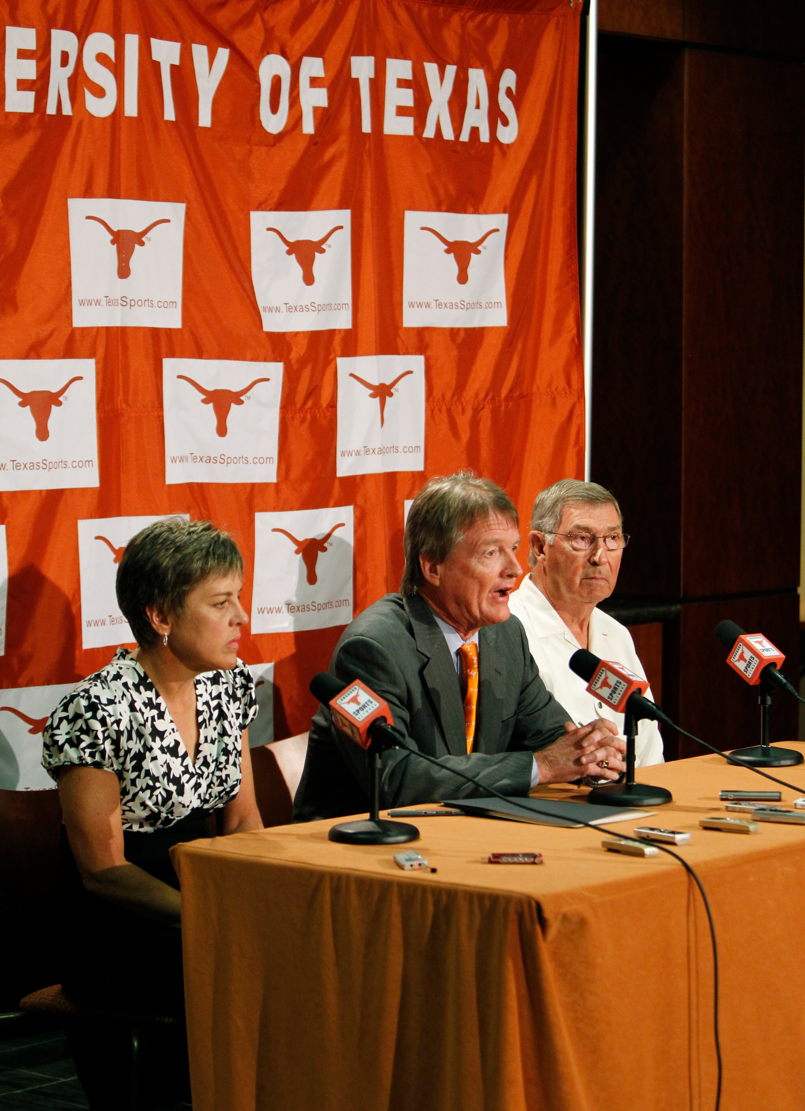 AUSTIN, TX - JUNE 15:  University of Texas at Austin President William Powers Jr., center, Women's Athletics Director Chris Plonskon, left, and Men's Athletics Director DeLoss Dodds, right, announce the athletics programs will continue competing in the Bi