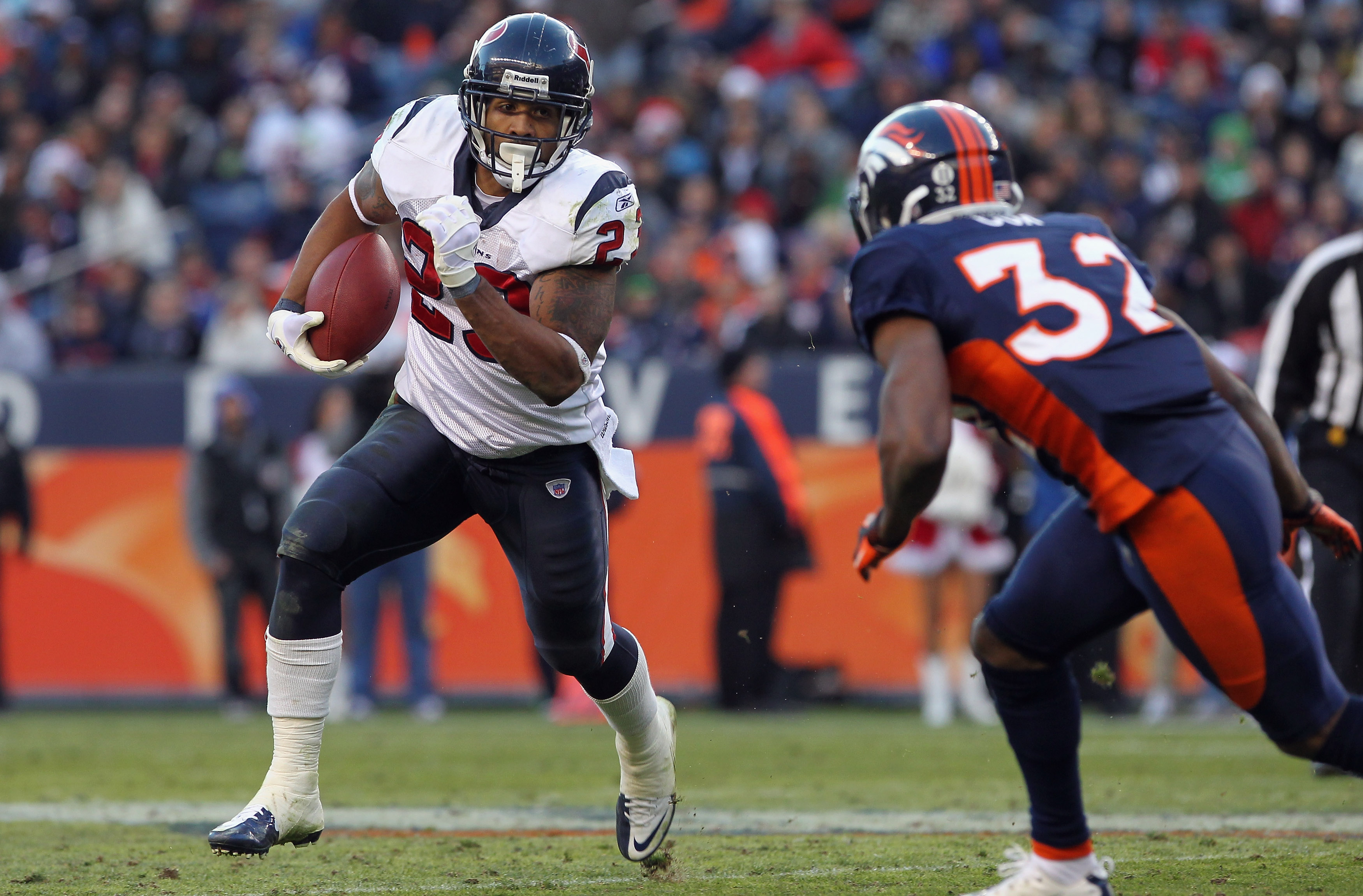 DENVER - DECEMBER 26: Running back Arian Foster #23 of the Houston Texas rushes with the ball as cornerback Perrish Cox #32 of the Denver Broncos defends at INVESCO Field at Mile High on December 26, 2010 in Denver, Colorado. The Broncos defeated the Tex DENVER - DECEMBER 26: Running back Arian Foster #23 of the Houston Texas rushes with the ball as cornerback Perrish Cox #32 of the Denver Broncos defends at INVESCO Field at Mile High on December 26, 2010 in Denver, Colorado. The Broncos defeated the Tex