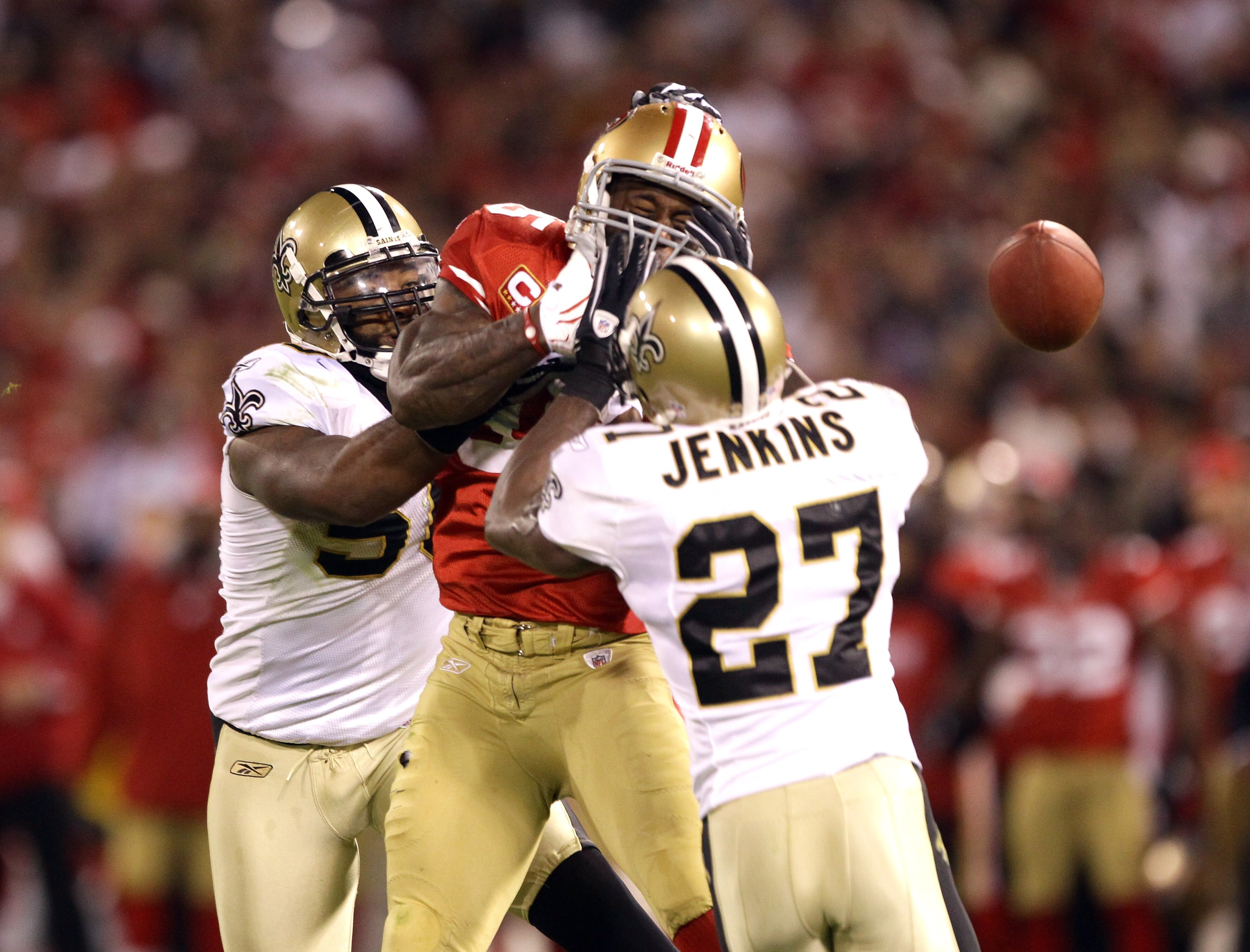 SAN FRANCISCO - SEPTEMBER 20:  Vernon Davis #85 of the San Francisco 49ers loses the ball while defended by Malcolm Jenkins #27 and Marvin Mitchell #50 of the New Orleans Saints at Candlestick Park on September 20, 2010 in San Francisco, California.  (Pho