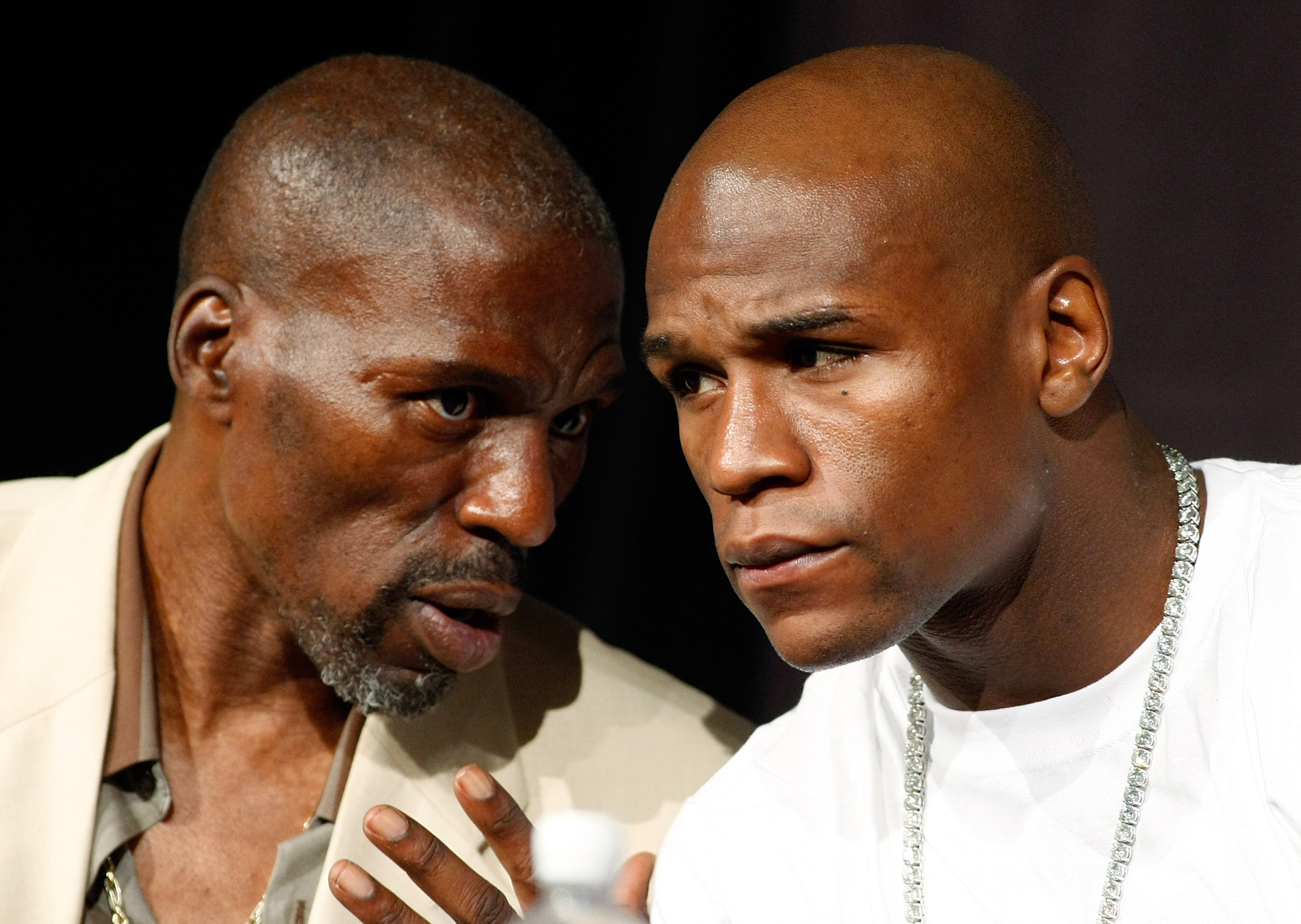 LAS VEGAS - SEPTEMBER 16:  Boxer Floyd Mayweather Jr. (R) and his uncle and trainer Roger Mayweather confer during the final news conference for their bout against Juan Manuel Marquez at the MGM Grand Hotel/Casino September 16, 2009 in Las Vegas, Nevada.