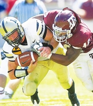 The young man on the left is wearing my combat patch, the 1st Cavalry Division, and will professionally defend the freedom of the man tackling him, Texas A&M linebacker Von Miller.