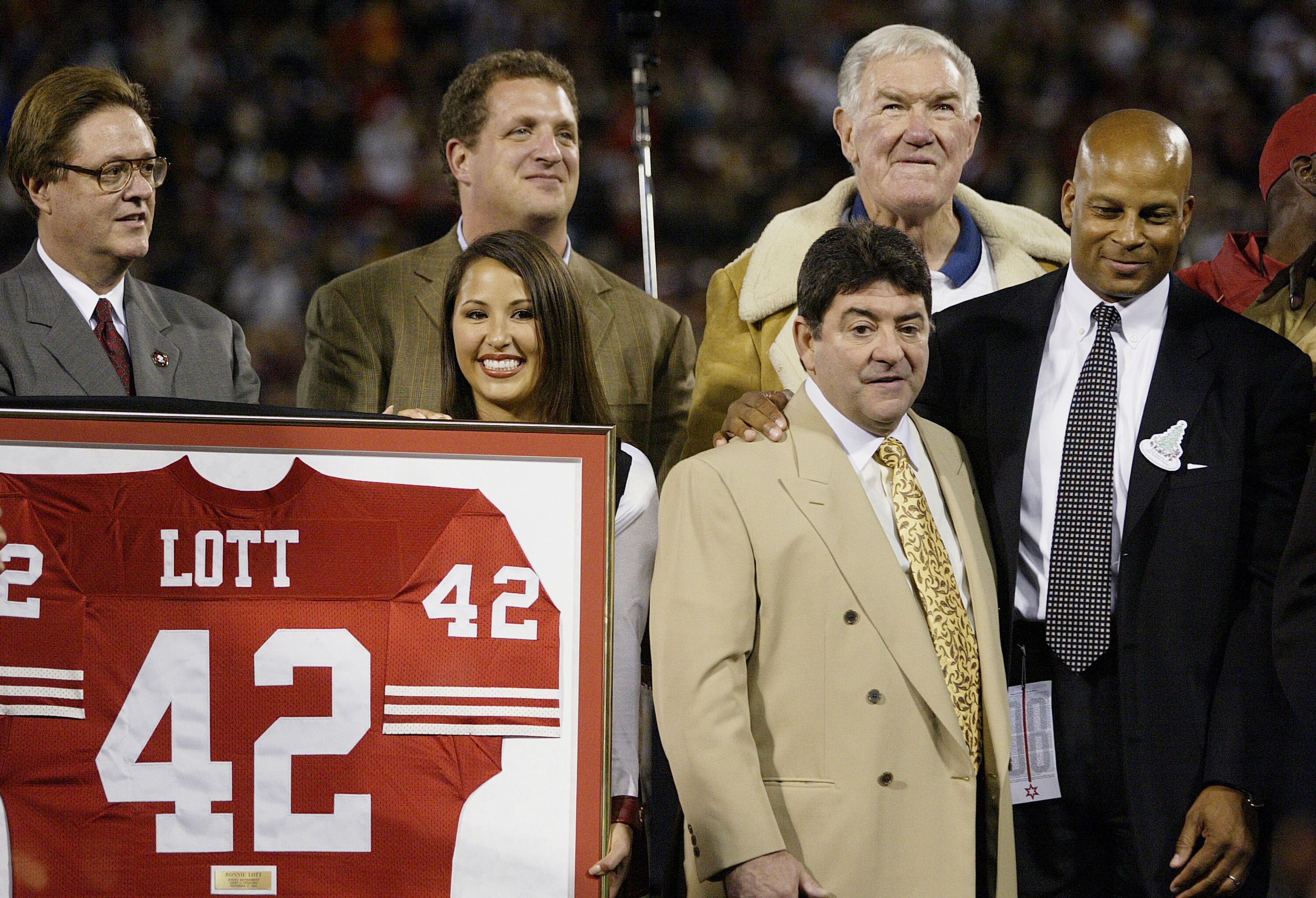 SAN FRANCISCO - NOVEMBER 17:  Former San Francisco 49er Ronnie Lott (R) has his #42 jersey retired during a ceremony with former owner Ed DeBartotlo Jr. , former teammates and family at halftime during the Pittsburgh Steelers v San Francisco 49ers game on