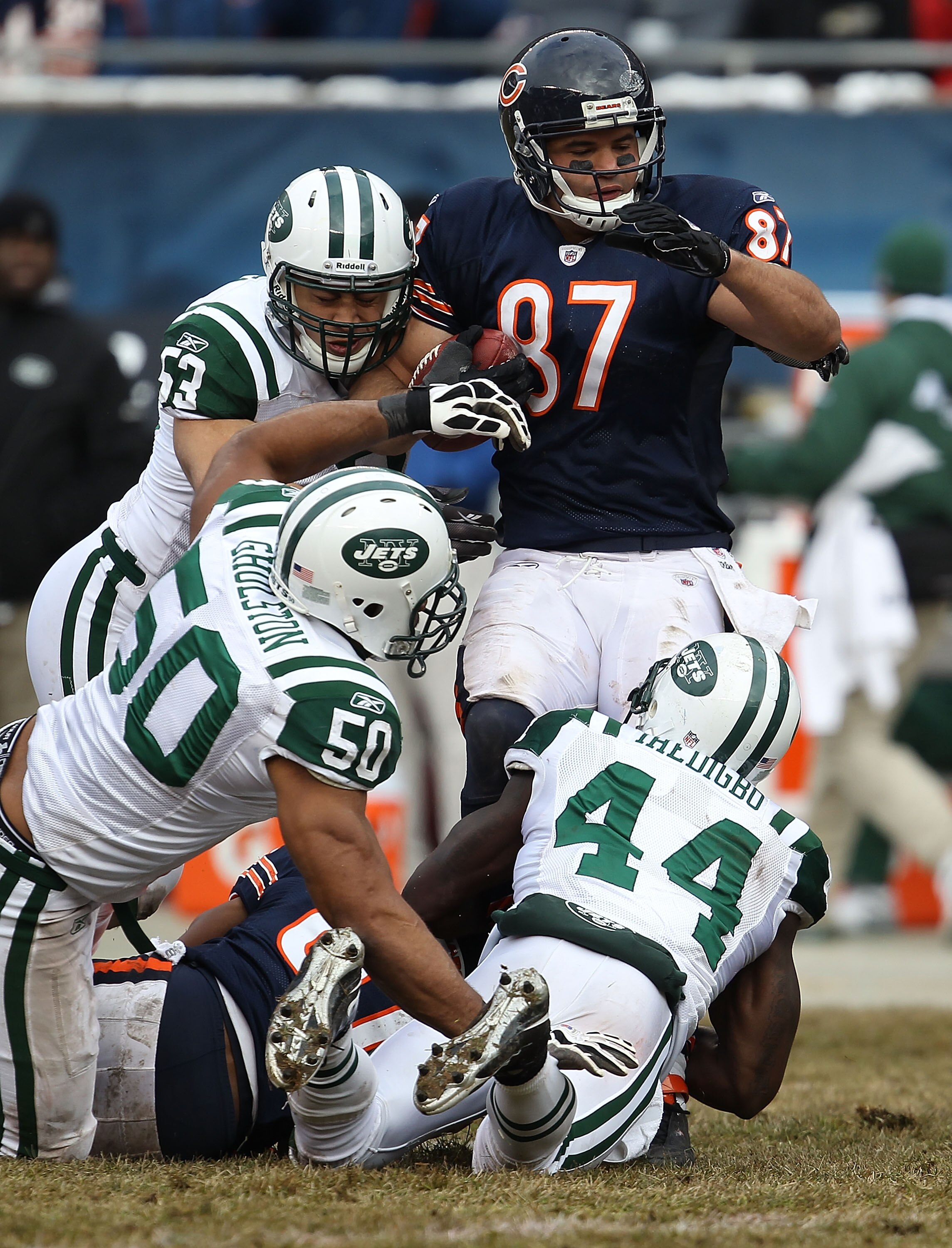CHICAGO, IL - DECEMBER 26: Kellen Davis #87 of the Chicago Bears is tackled by Josh Mauga #53, Vernon Gholston #50 and James Ihedigbo #44 of the New York Jets at Soldier Field on December 26, 2010 in Chicago, Illinois. The Bears defeated the Jets 38-34. (