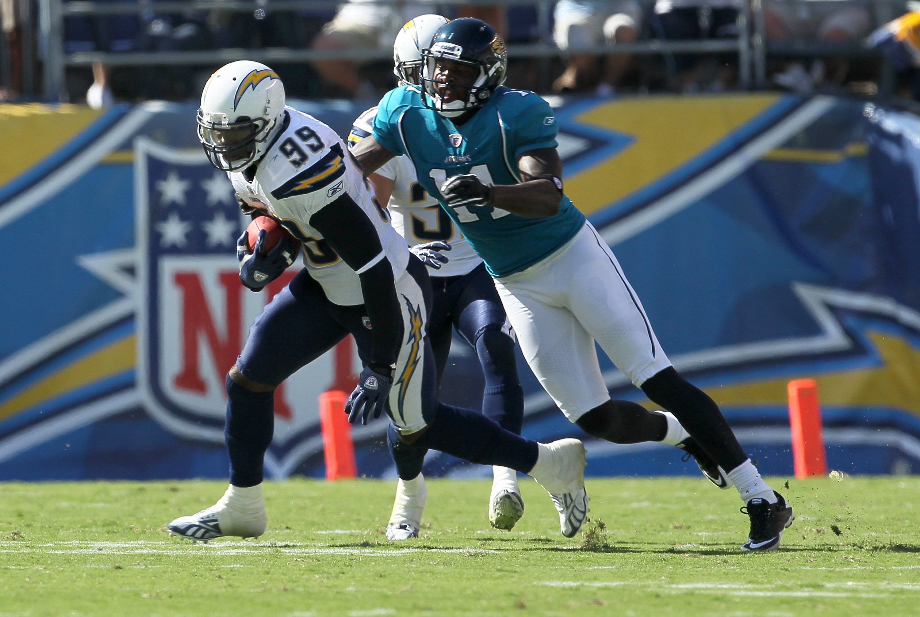 SAN DIEGO - SEPTEMBER 19:  Linebacker Kevin Burnett #99 of the San Diego Chargers returns an interception in front of wide receiver Mike Sims-Walker #11 of the Jacksonville Jaguars at Qualcomm Stadium on September 19, 2010 in San Diego, California. The Ch