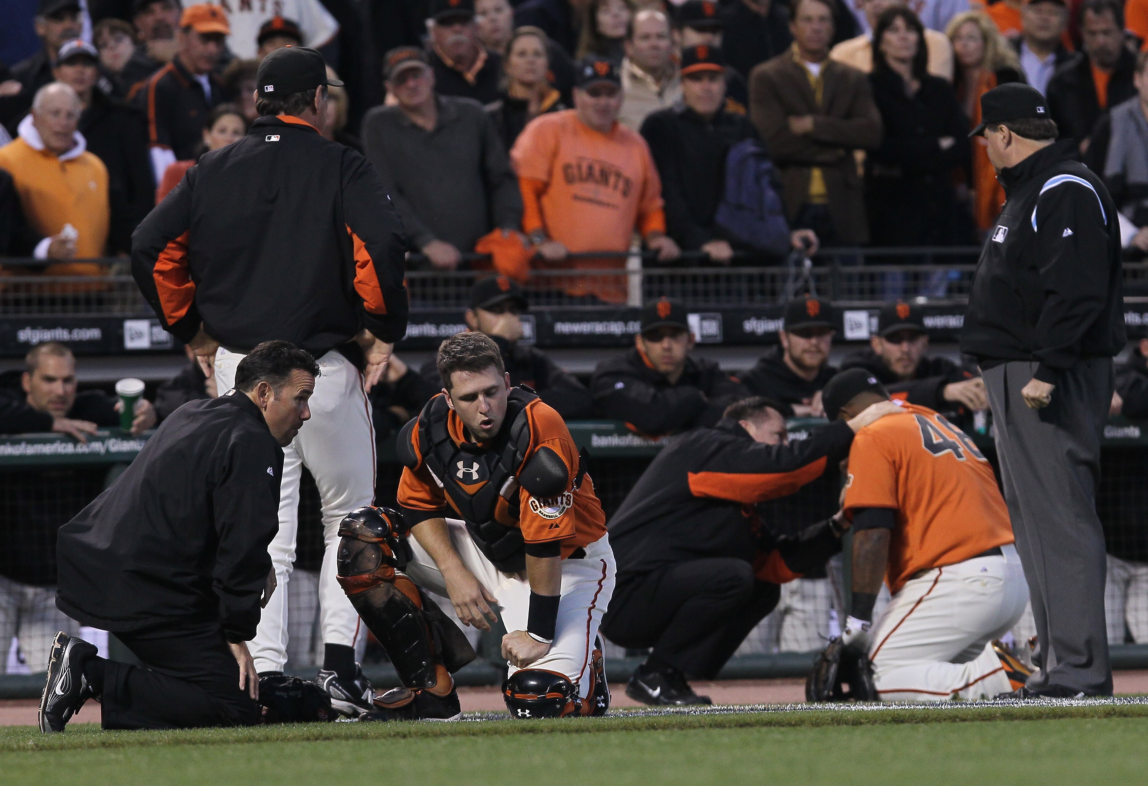 SAN FRANCISCO - OCTOBER 08:  Buster Posey #28 of the San Francisco Giants recovers after colliding with Pablo Sandoval #48 trying to field a foul ball during the first inning of the National League Division Series with the Atlanta Braves at AT&T Park on O