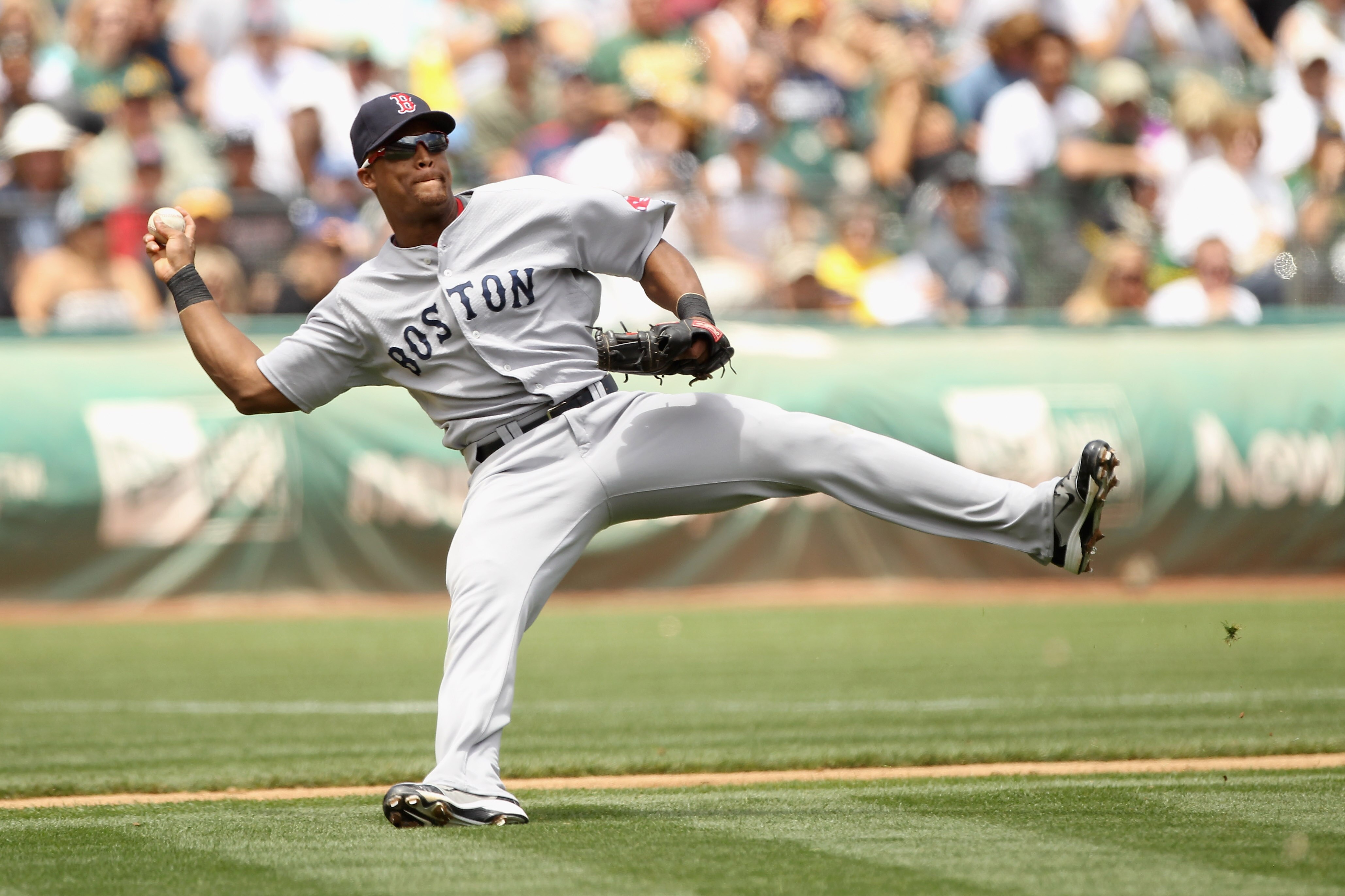 OAKLAND, CA - JULY 21:  Adrian Beltre #29 of the Boston Red Sox makes a play on a bunt by Rajai Davis #11 of the Oakland Athletics at the Oakland-Alameda County Coliseum on July 21, 2010 in Oakland, California.  Davis was safe at first base. (Photo by Ezr