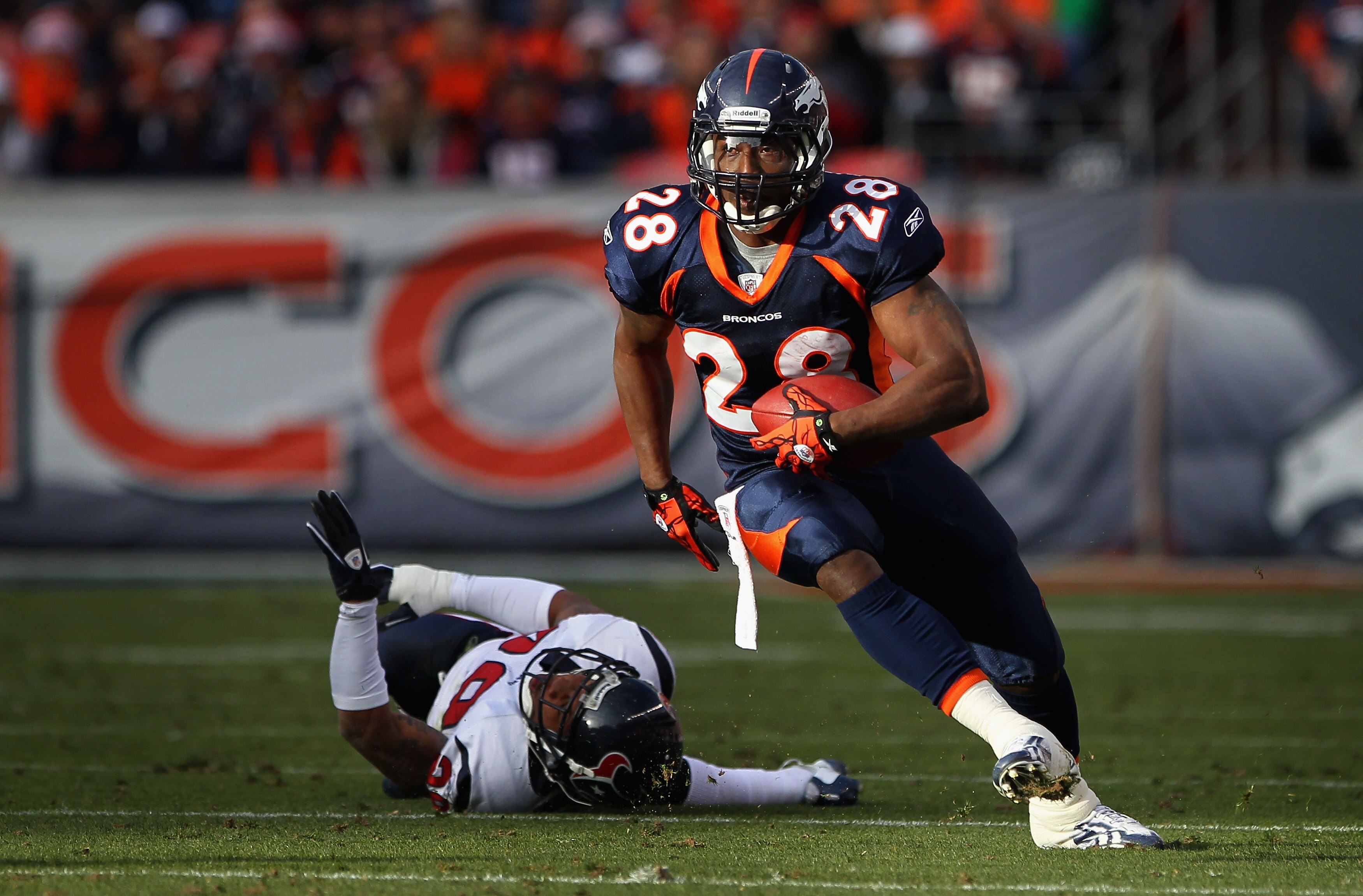 DENVER - DECEMBER 26:  Running back Correll Buckhalter #28 of the Denver Broncos picks up yardage after eluding cornerback Glover Quin #29 of the Houston Texans at INVESCO Field at Mile High on December 26, 2010 in Denver, Colorado. The Broncos defeated t