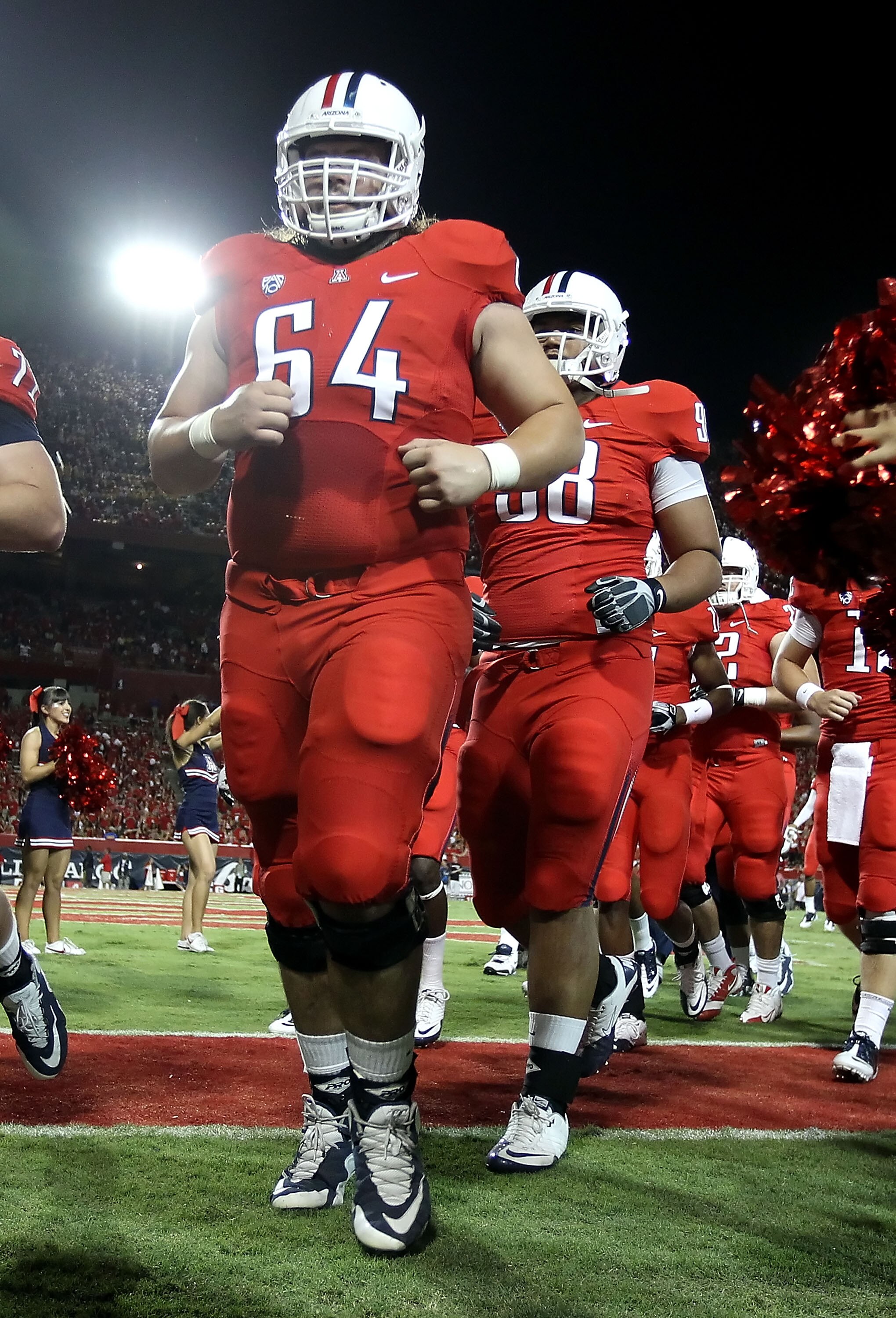 TUCSON, AZ - SEPTEMBER 18:  Center Colin Baxter #64 of the Arizona Wildcats walks off the field after warm ups to the college football game against the Iowa Hawkeyes at Arizona Stadium on September 18, 2010 in Tucson, Arizona.  The Wildcats defeated the H