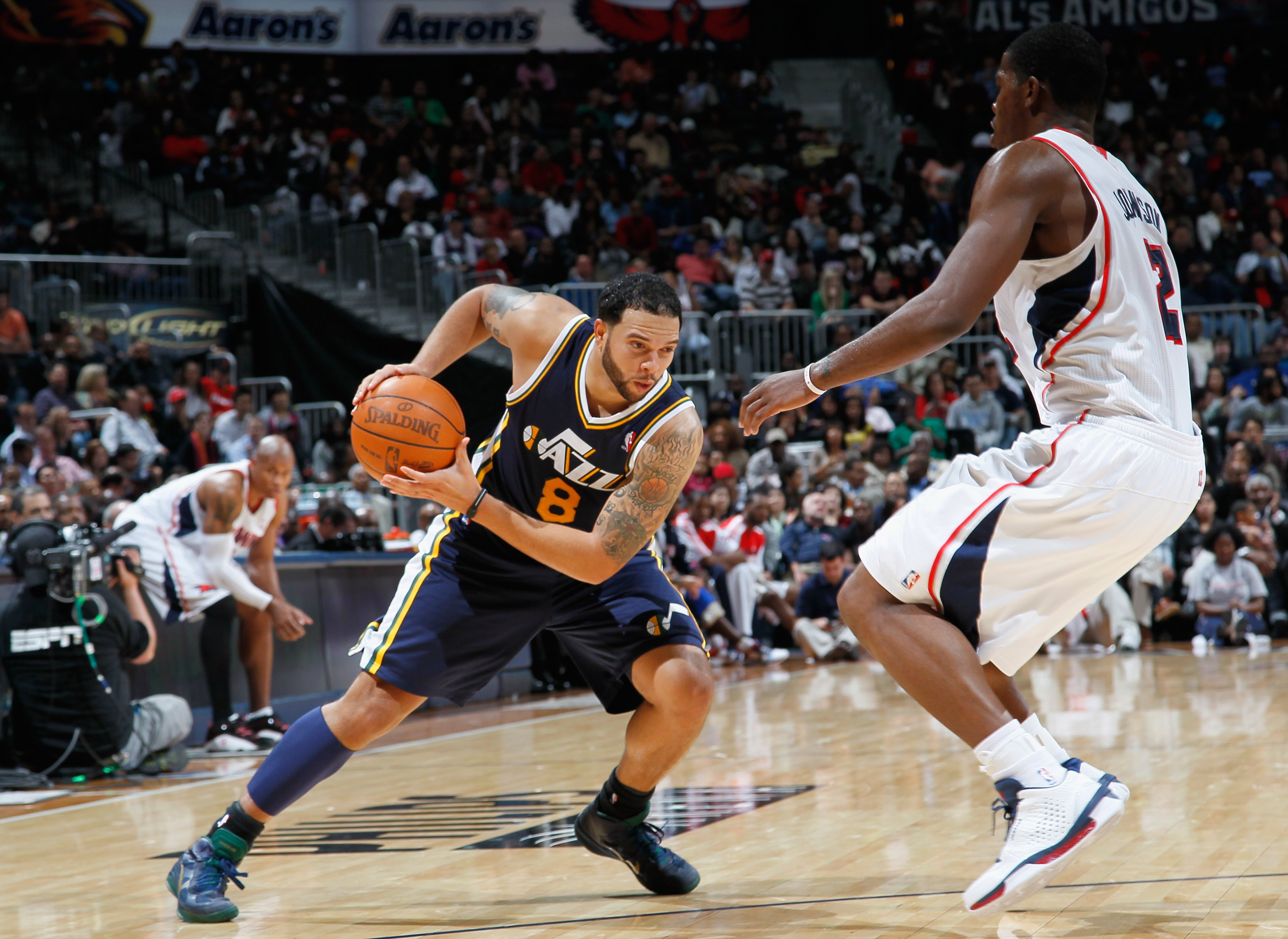 ATLANTA - NOVEMBER 12:  Deron Williams #8 of the Utah Jazz drives against Joe Johnson #2 of the Atlanta Hawks at Philips Arena on November 12, 2010 in Atlanta, Georgia.  NOTE TO USER: User expressly acknowledges and agrees that, by downloading and/or usin