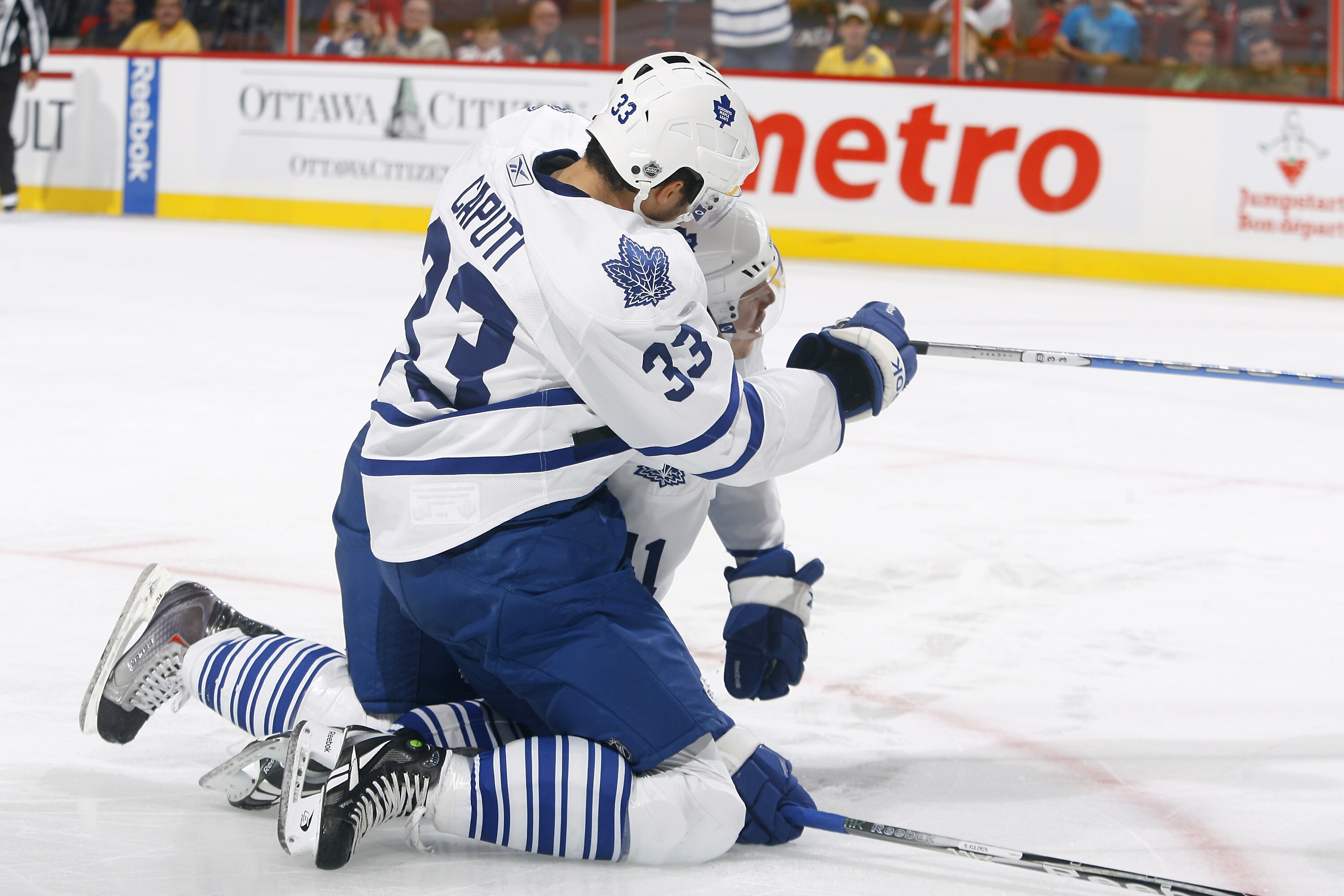 KANATA, ON - SEPTEMBER 29: Nikolai Kulemin #41 of the Toronto Maple Leafs is mobbed by teammate Luca Caputi #33 after scoring a goal against the Ottawa Senators during a game at Scotiabank Place on September 29, 2010 in Kanata, Canada.  (Photo by Phillip