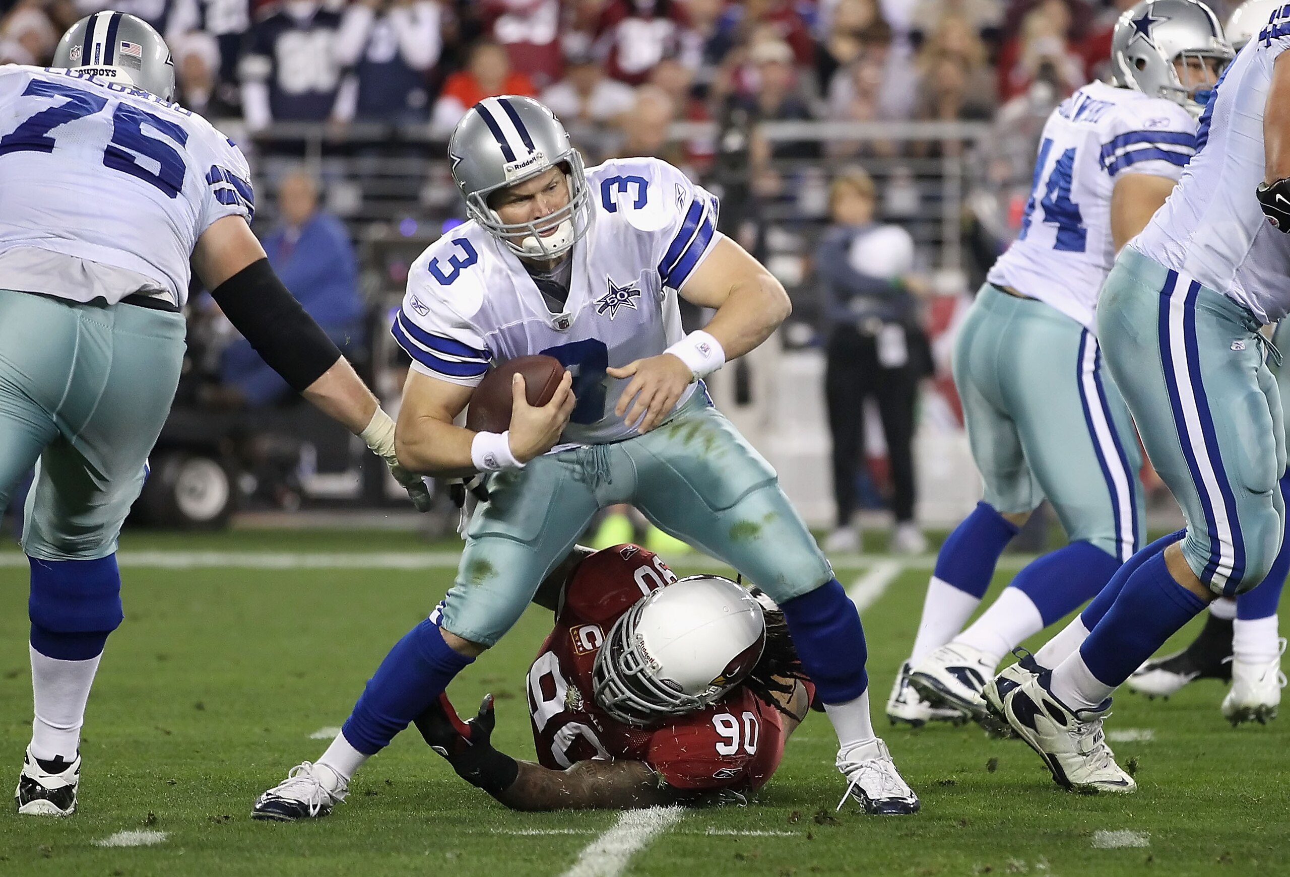 GLENDALE, AZ - DECEMBER 25:  Quarterback Jon Kitna #3 of the Dallas Cowboys is sacked by Darnell Dockett #90 of the Arizona Cardinals during the second quarter of the NFL game at the University of Phoenix Stadium on December 25, 2010 in Glendale, Arizona.