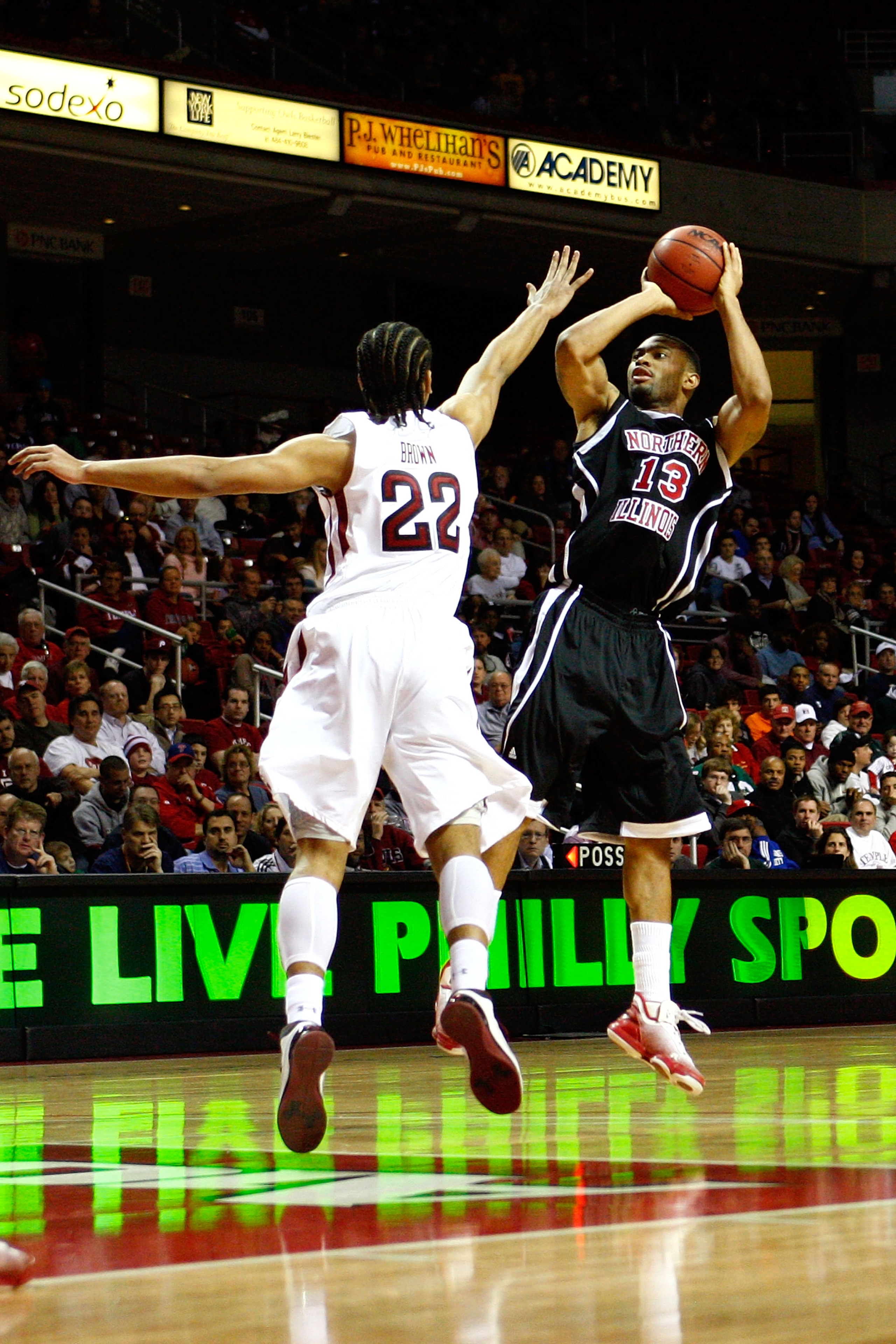PHILADELPHIA, PA - DECEMBER 18: Xavier Silas #13 of the Northern Illinois Huskies attempts a shot against Aaron Brown #22 of the Temple Owls at the Liacouras Center on December 18, 2010 in Philadelphia, Pennsylvania. (Photo by Chris Chambers/Getty Image PHILADELPHIA, PA - DECEMBER 18: Xavier Silas #13 of the Northern Illinois Huskies attempts a shot against Aaron Brown #22 of the Temple Owls at the Liacouras Center on December 18, 2010 in Philadelphia, Pennsylvania. (Photo by Chris Chambers/Getty Image