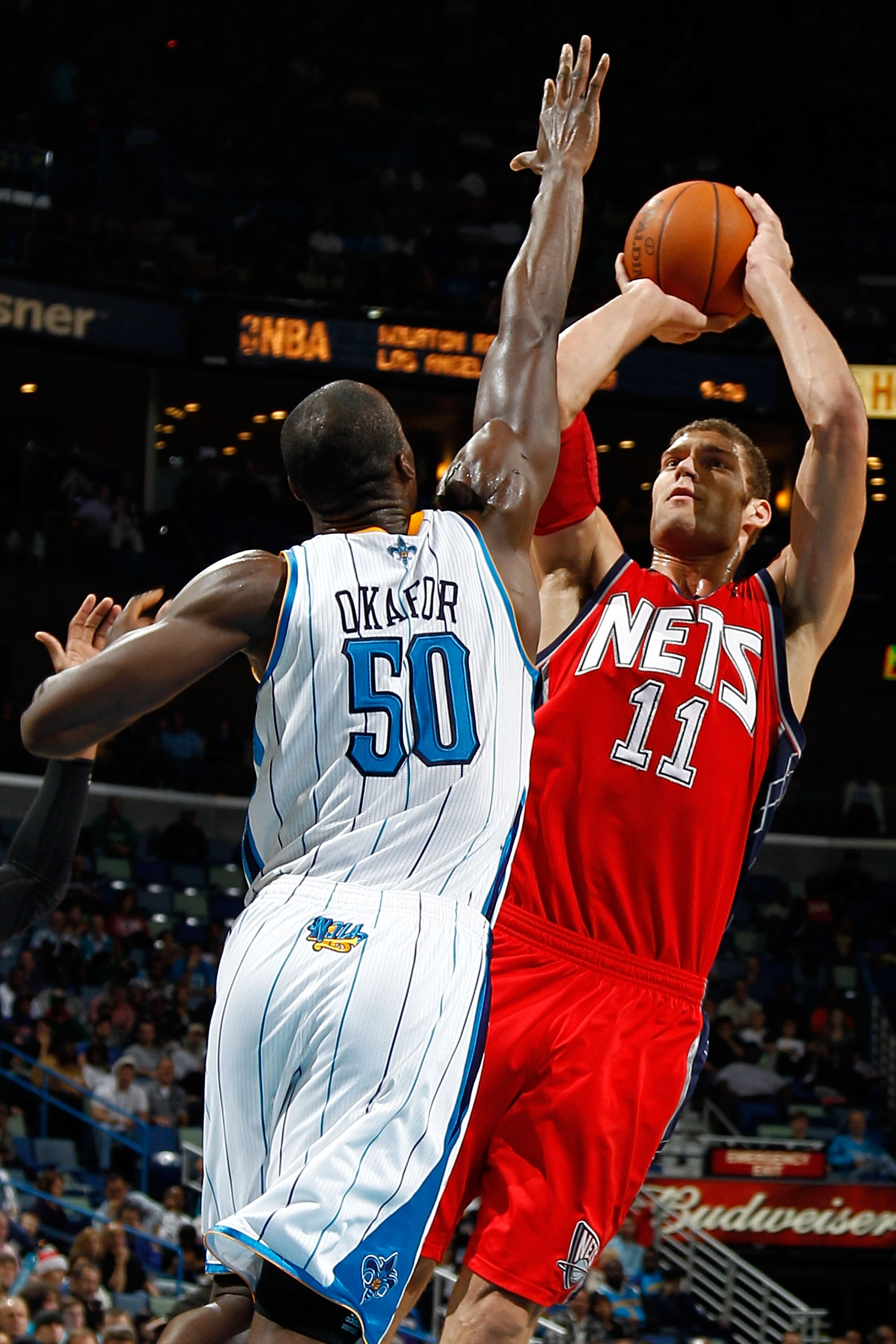 NEW ORLEANS, LA - DECEMBER 22:  Brook Lopez #11 of the New Jersey Nets shoots the ball over Emeka Okafor #50 of the New Orleans Hornets at the New Orleans Arena on December 22, 2010 in New Orleans, Louisiana.    The Hornets defeated the Nets 105-91.   NOT