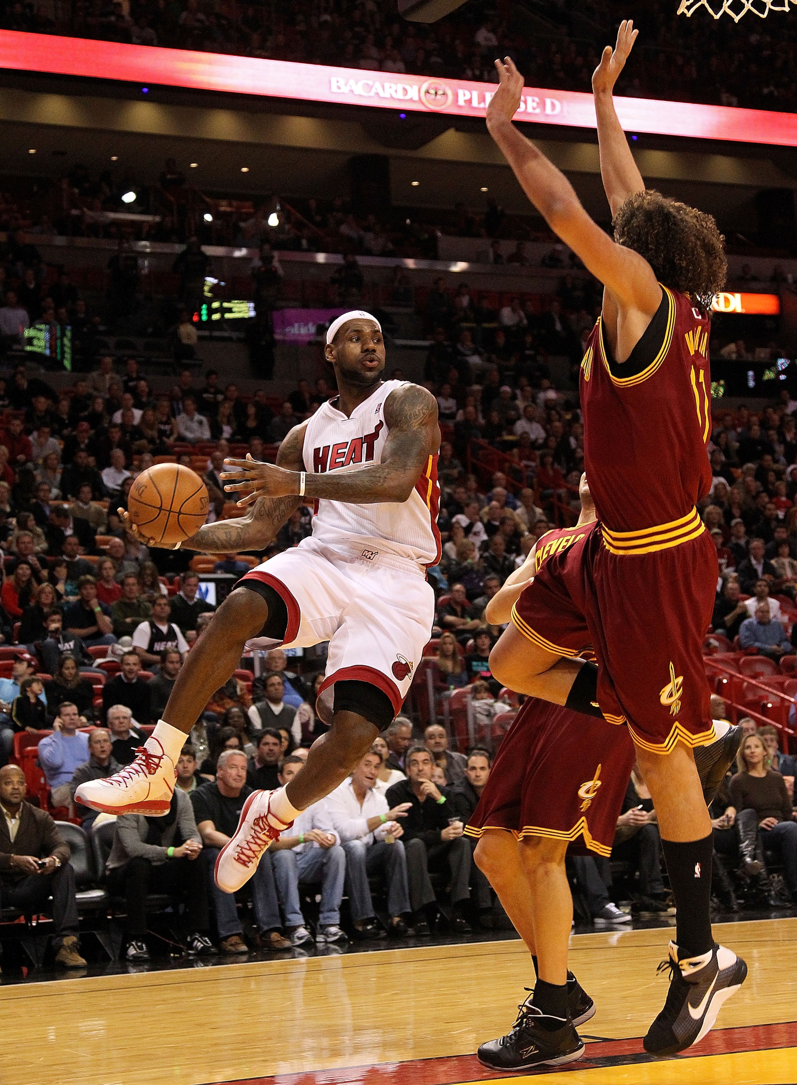 MIAMI, FL - DECEMBER 15: LeBron James #6 of the Miami Heat passes around Anderson Varejao #17 of the Cleveland Cavaliers during a game at American Airlines Arena on December 15, 2010 in Miami, Florida. NOTE TO USER: User expressly acknowledges and agree MIAMI, FL - DECEMBER 15: LeBron James #6 of the Miami Heat passes around Anderson Varejao #17 of the Cleveland Cavaliers during a game at American Airlines Arena on December 15, 2010 in Miami, Florida. NOTE TO USER: User expressly acknowledges and agree