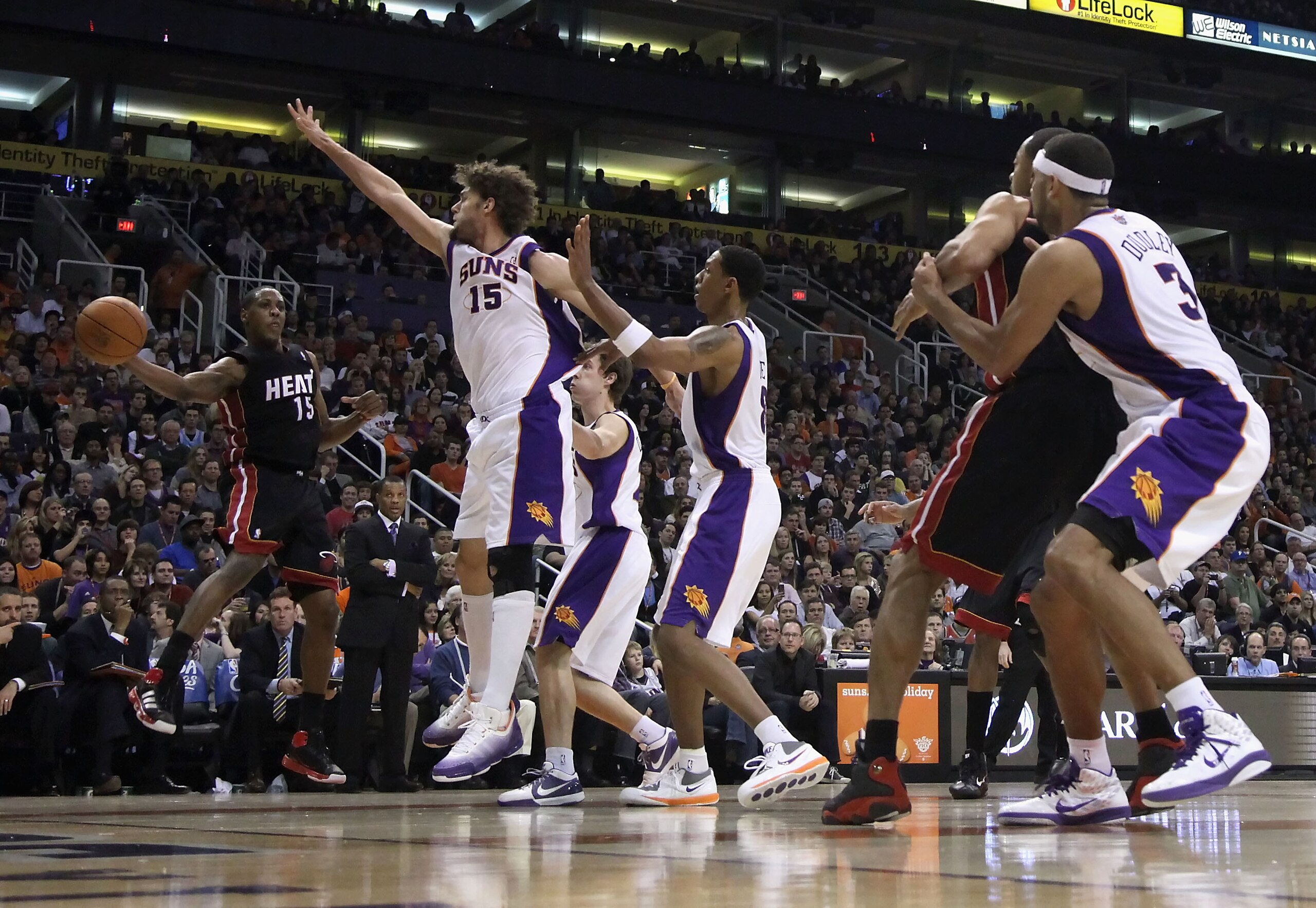 PHOENIX - DECEMBER 23: Mario Chalmers #15 of the Miami Heat passes the ball during the NBA game against the Phoenix Suns at US Airways Center on December 23, 2010 in Phoenix, Arizona. The Heat defeated the Suns 95-83. NOTE TO USER: User expressly ackno PHOENIX - DECEMBER 23: Mario Chalmers #15 of the Miami Heat passes the ball during the NBA game against the Phoenix Suns at US Airways Center on December 23, 2010 in Phoenix, Arizona. The Heat defeated the Suns 95-83. NOTE TO USER: User expressly ackno