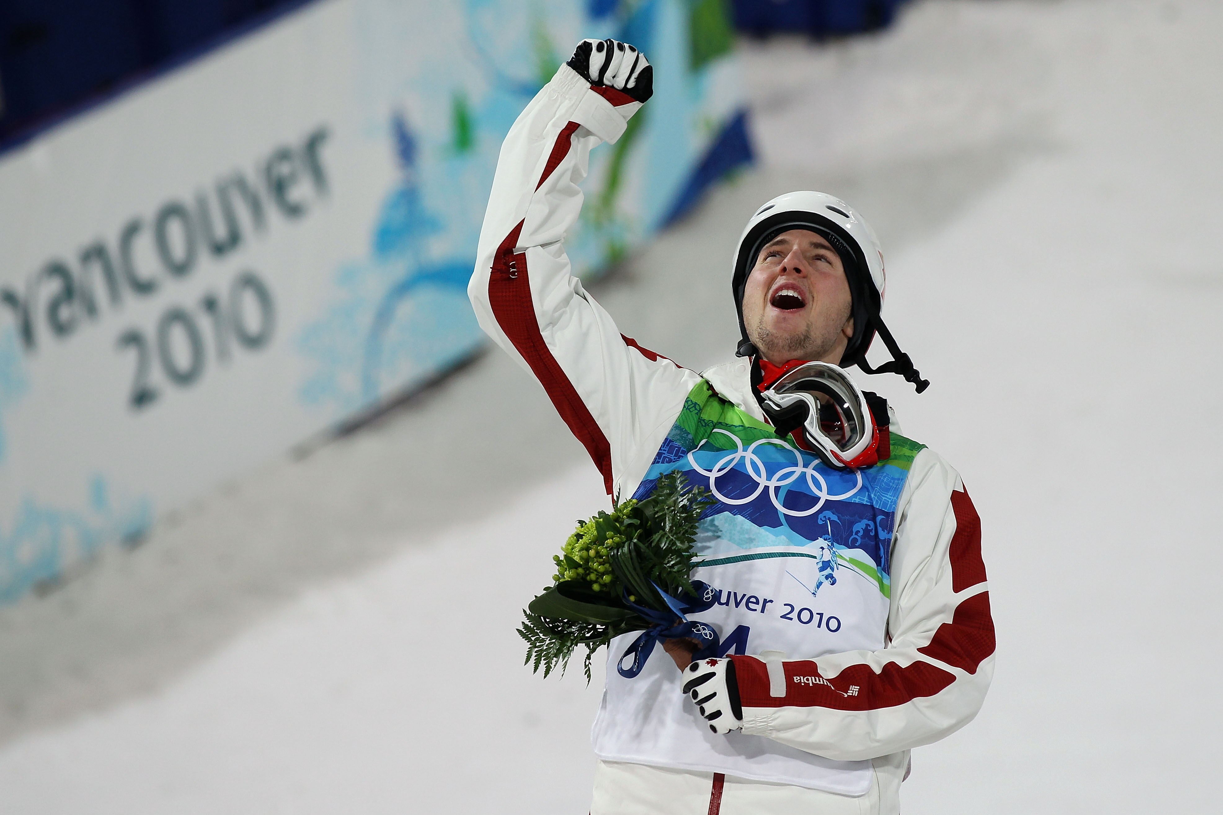 VANCOUVER, BC - FEBRUARY 14:  Alexandre Bilodeau of Canada celebrates winning the gold medal during the flower ceremony for the Freestyle Skiing Men's Moguls on day 3 of the 2010 Winter Olympics at Cypress Freestyle Skiing Stadium on February 14, 2010 in