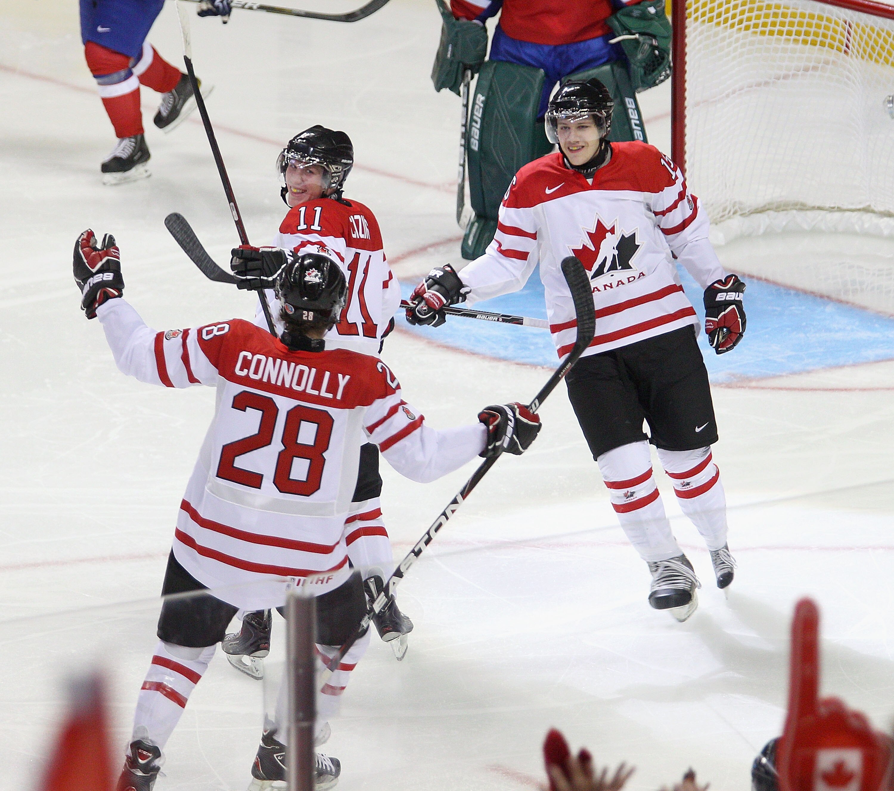 BUFFALO, NY - DECEMBER 29: Brett Connolly #28, Casey Cizikas #11 and Curtis Hamilton #16  of Canada celebrate Cizikas' goal in the first period against Norway during the 2011 IIHF World U20 Championship game between the Canada and Norway at the HSBC Arena
