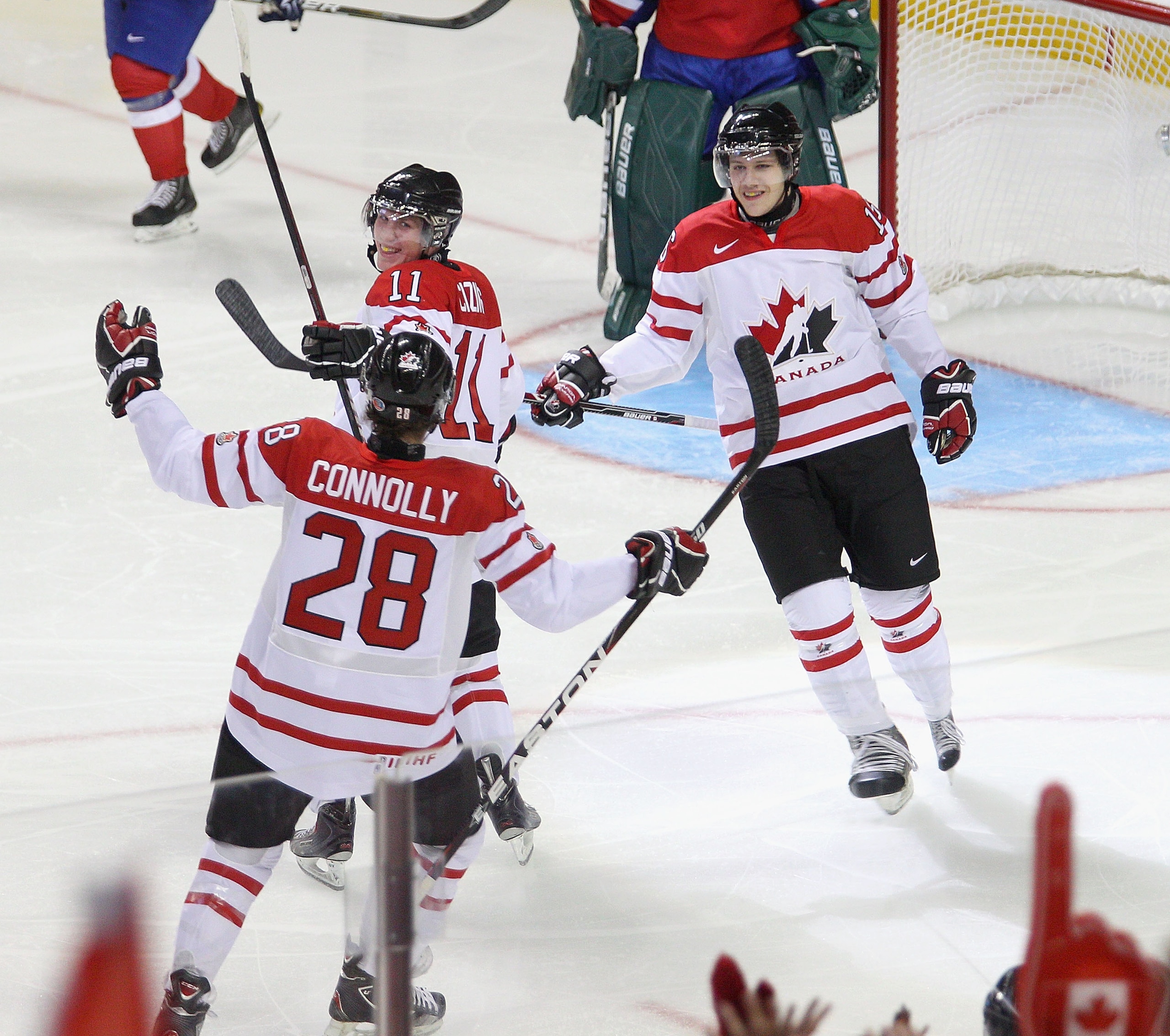 BUFFALO, NY - DECEMBER 29: Brett Connolly #28, Casey Cizikas #11 and Curtis Hamilton #16  of Canada celebrate Cizikas' goal in the first period against Norway during the 2011 IIHF World U20 Championship game between the Canada and Norway at the HSBC Arena