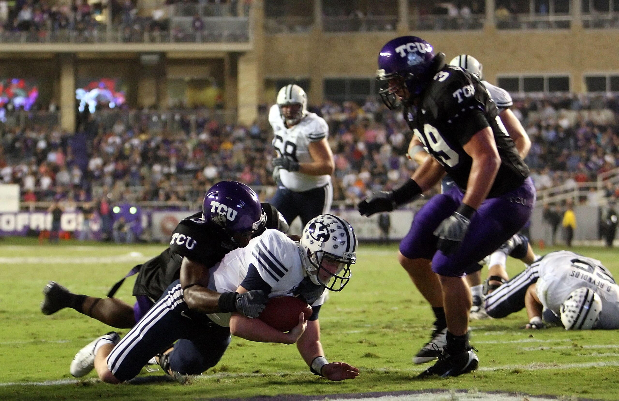 FORT WORTH, TX - OCTOBER 16:  Quarterback Max Hall #15 of the BYU Cougars dives for a touchdown against Tejay Johnson #3 of the TCU Horned Frogs in the third quarter at Amon G. Carter Stadium on October 16, 2008 in Fort Worth, Texas.  (Photo by Ronald Mar