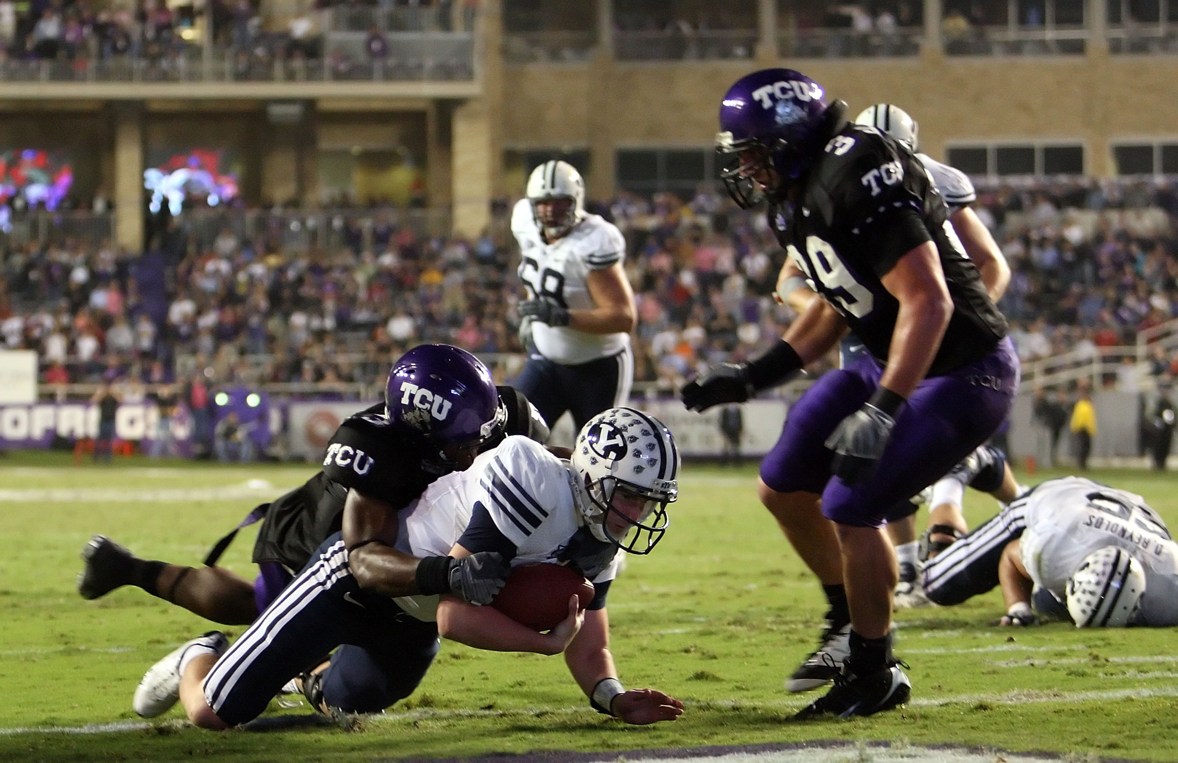 FORT WORTH, TX - OCTOBER 16:  Quarterback Max Hall #15 of the BYU Cougars dives for a touchdown against Tejay Johnson #3 of the TCU Horned Frogs in the third quarter at Amon G. Carter Stadium on October 16, 2008 in Fort Worth, Texas.  (Photo by Ronald Mar