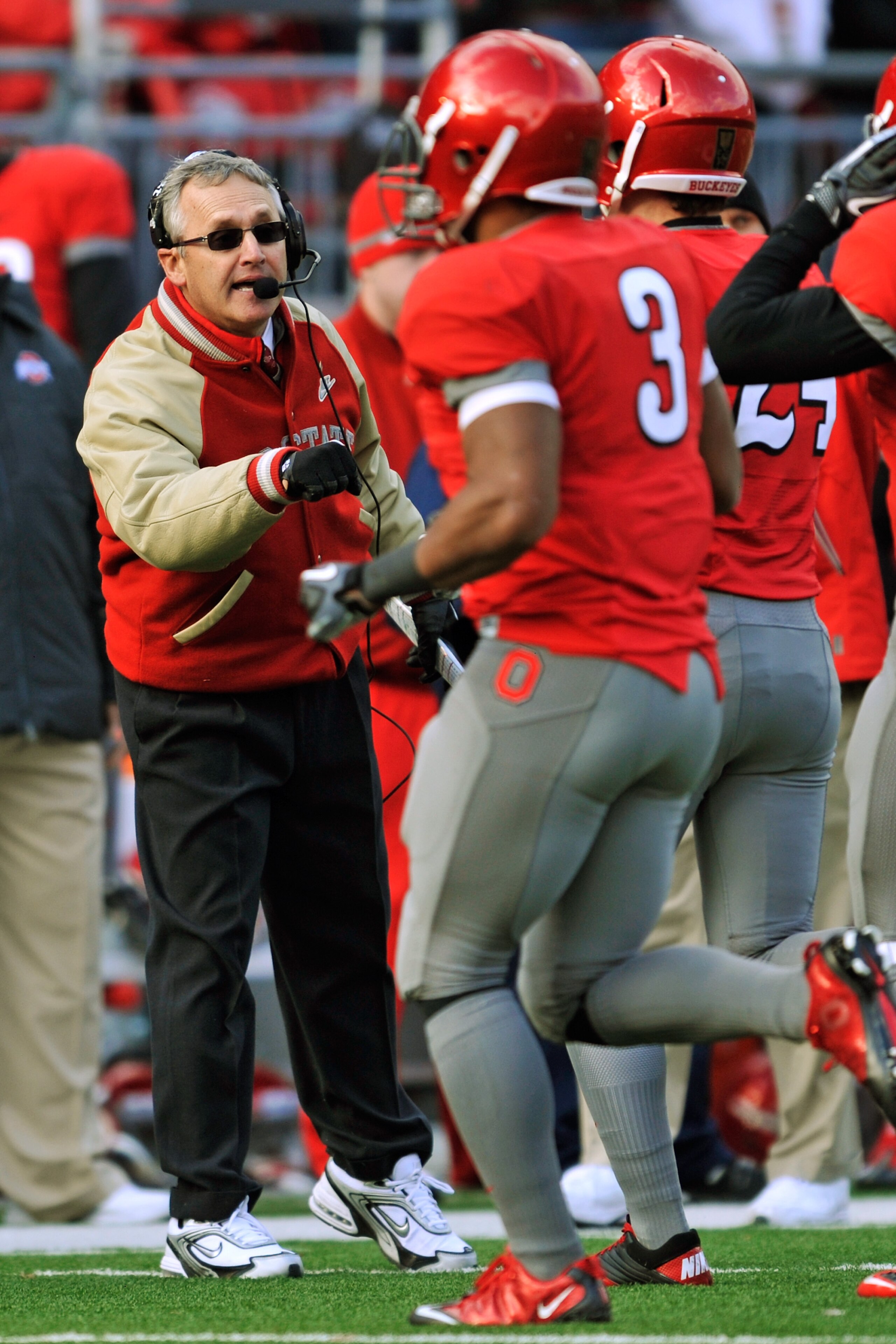 COLUMBUS, OH - NOVEMBER 27:  Head Coach Jim Tressel of the Ohio State Buckeyes fist bumps his players coming off the field during a game against the Michigan Wolverines at Ohio Stadium on November 27, 2010 in Columbus, Ohio. Ohio State defeated Michigan 3
