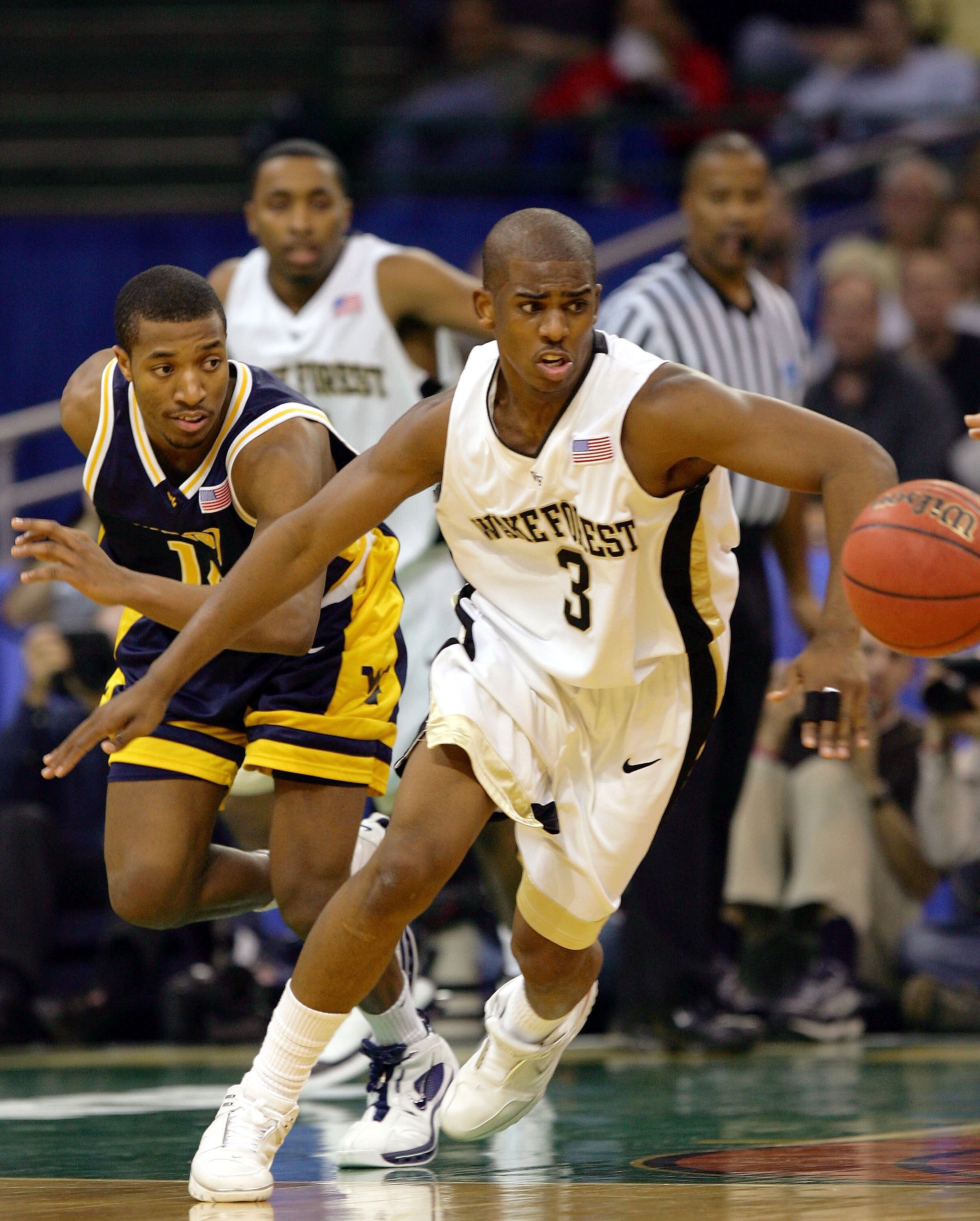 CLEVELAND - MARCH 19:  Chris Paul #3 of the Wake Forest Demon Deacons chases a loose ball ahead of Darris Nichols #14 of the West Virginia Mountaineers during the second round of the 2005 NCAA Championship on March 19, 2005 at the Wolstein Center in Cleve